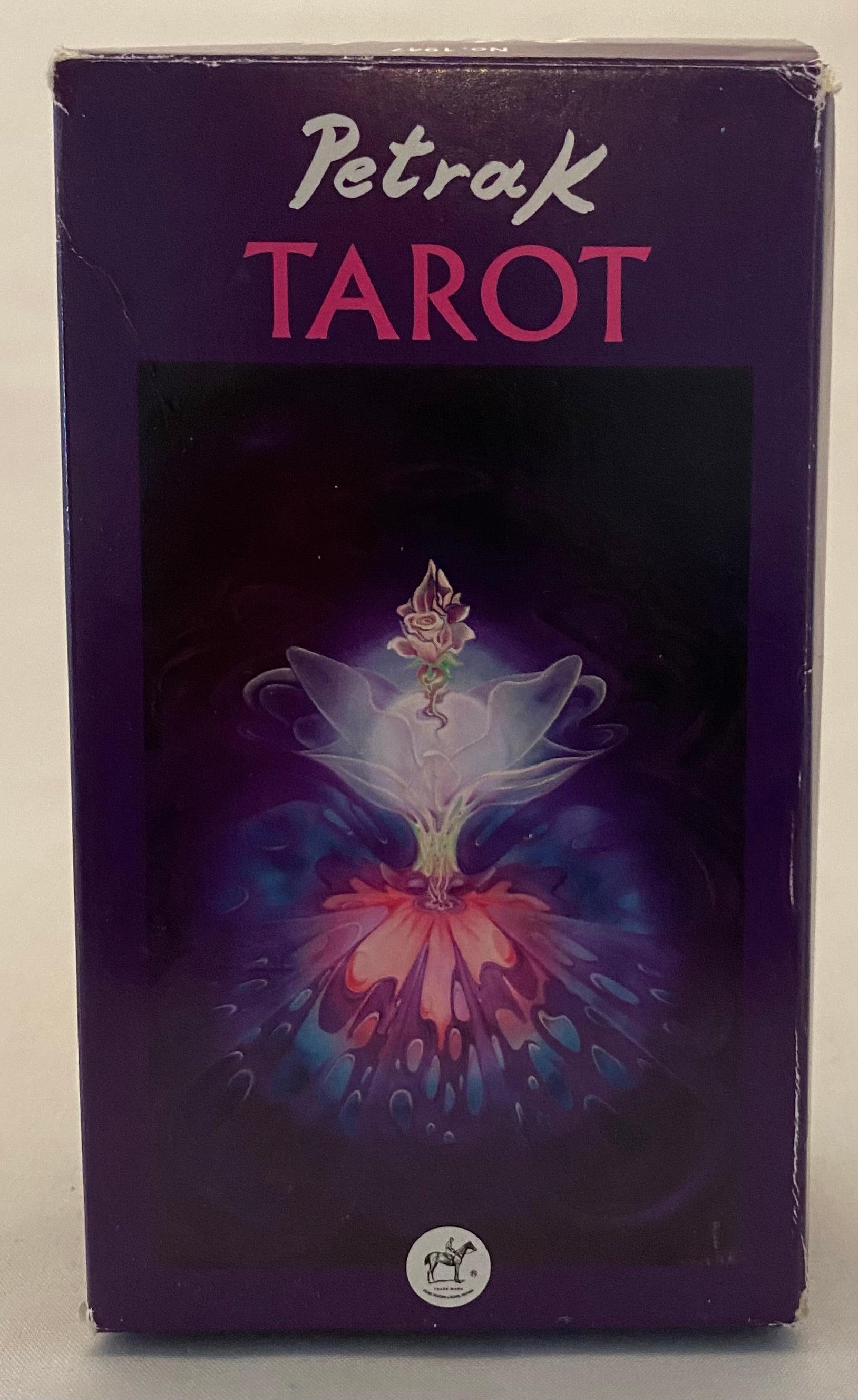 Petrak Tarot card box with a colorful design on a purple background