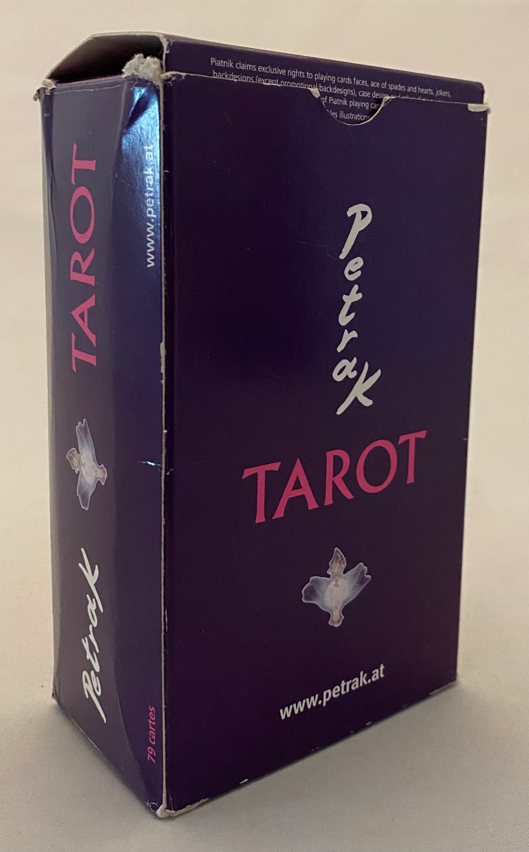 Purple Tarot card box with 'Petrak Tarot' branding on a beige background