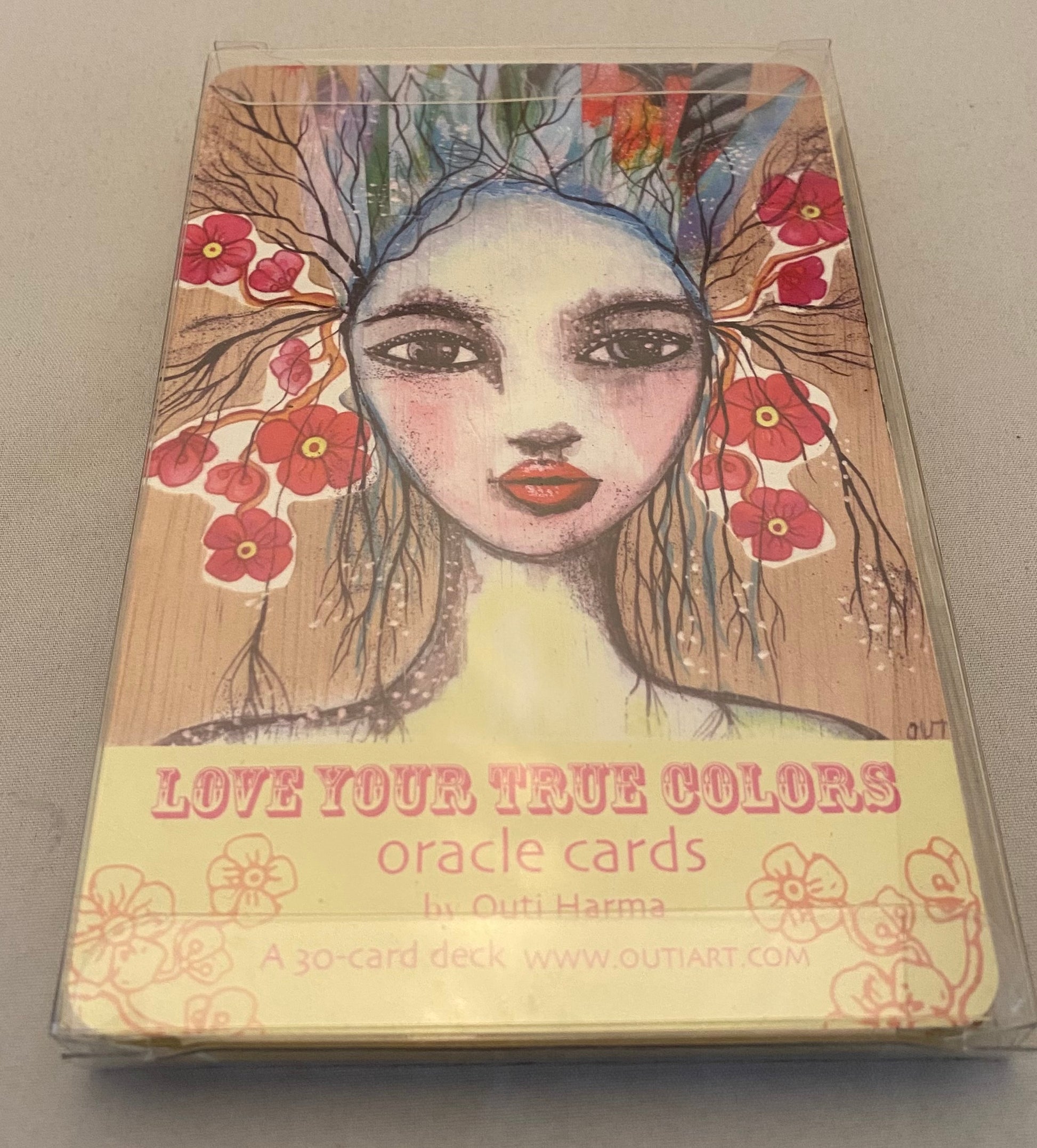 Love Your True Colors Oracle; portrait of a woman with red flowers in hair.