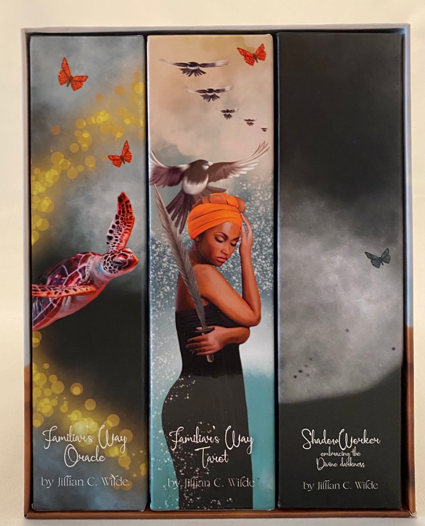 Tarot box set, Three Tarot  covers with artistic designs and text on a box