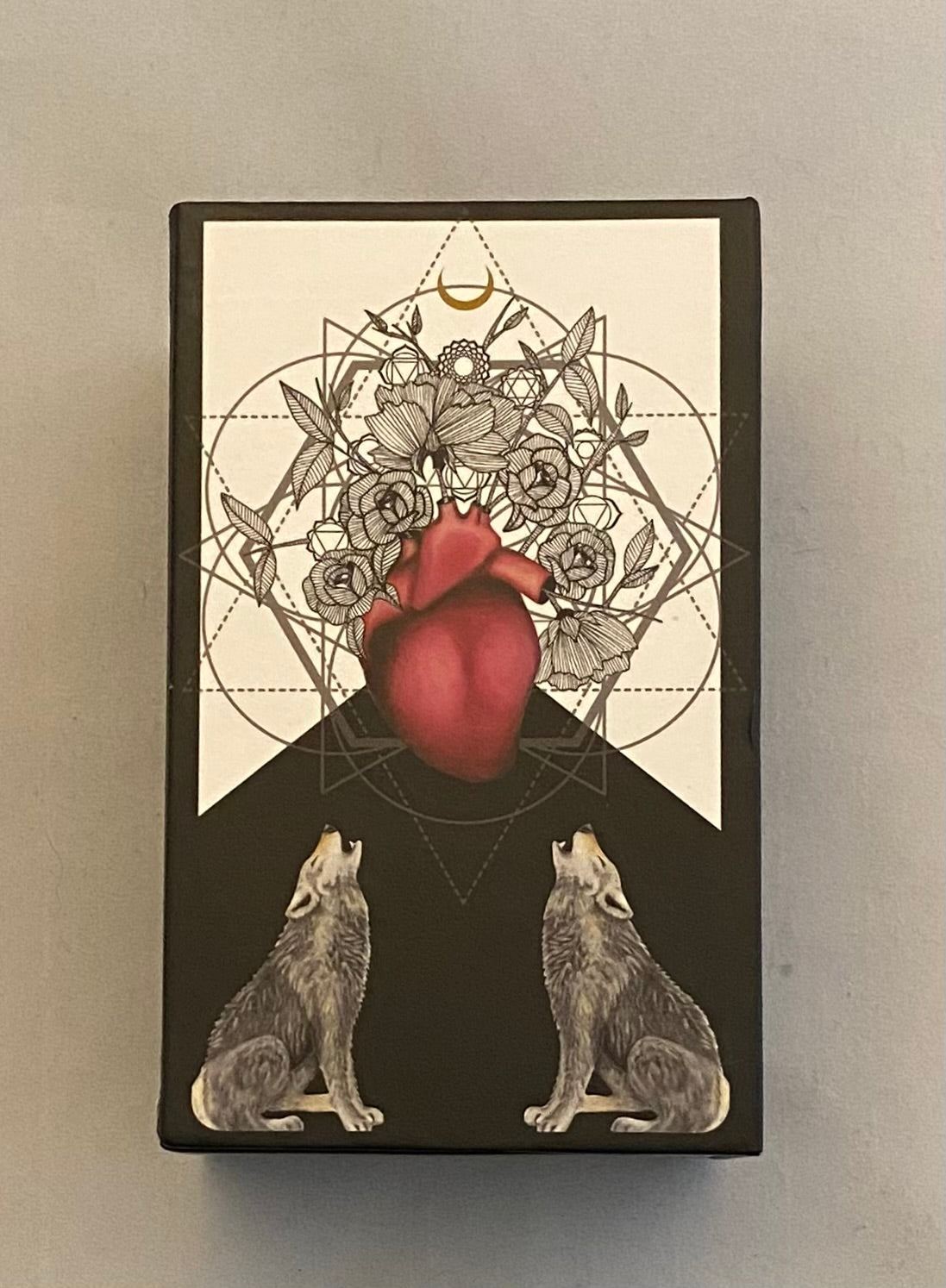 Black and White Tarot Box with a red heart, floral design, and two wolves on a beige background