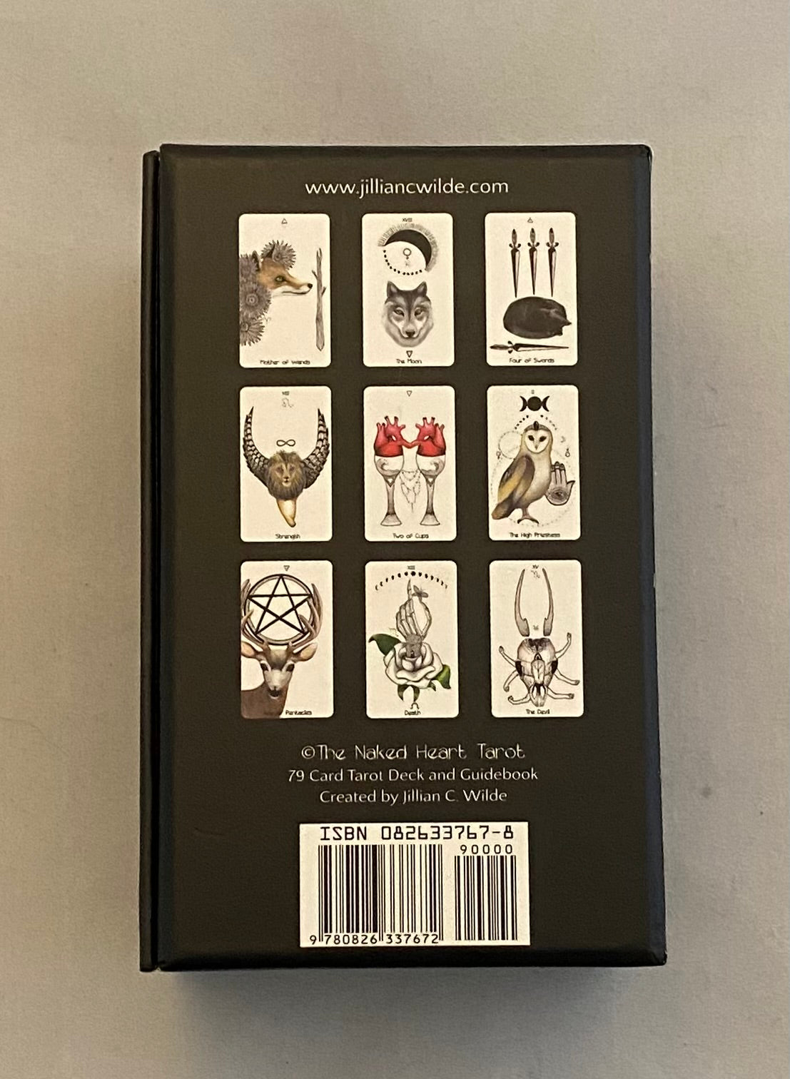 Back cover of a book with tarot card illustrations and branding on a gray background