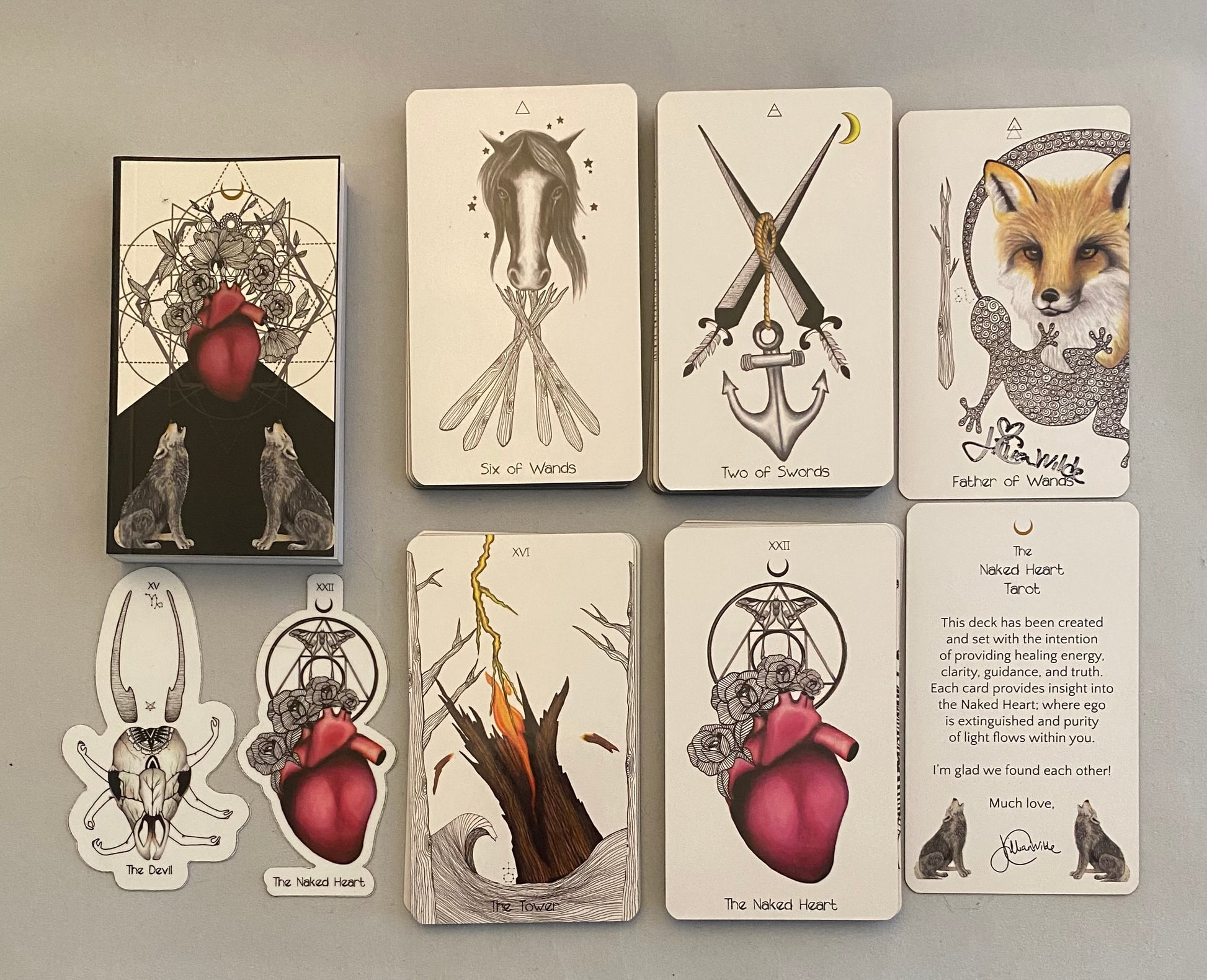 Set of tarot cards with artistic designs on a gray background
