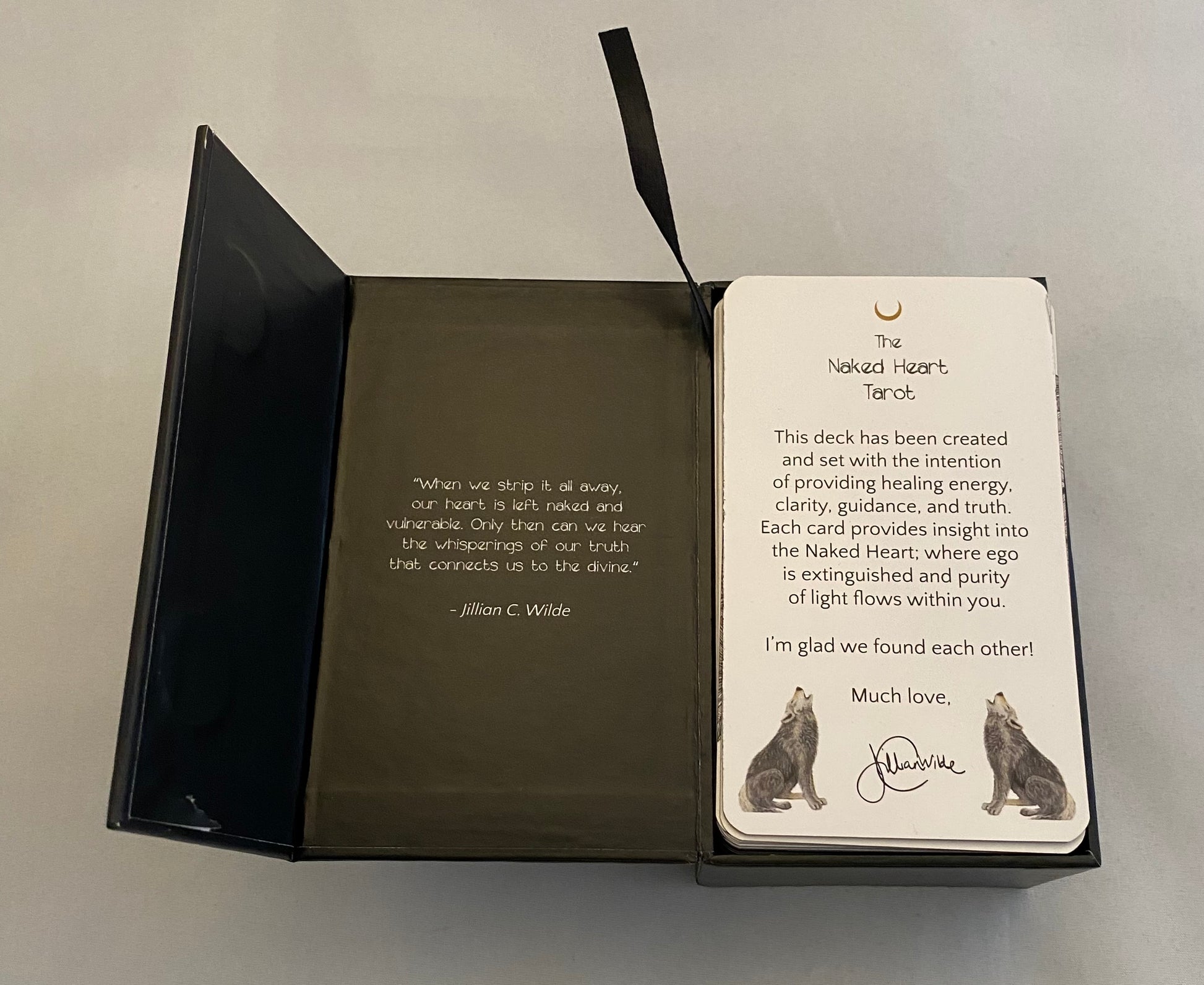 Open tarot box with text and illustrations on a plain background