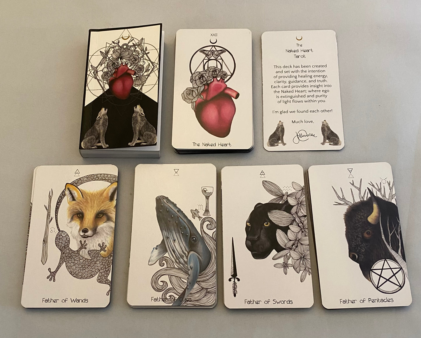 Set of tarot cards with animal illustrations on a gray background