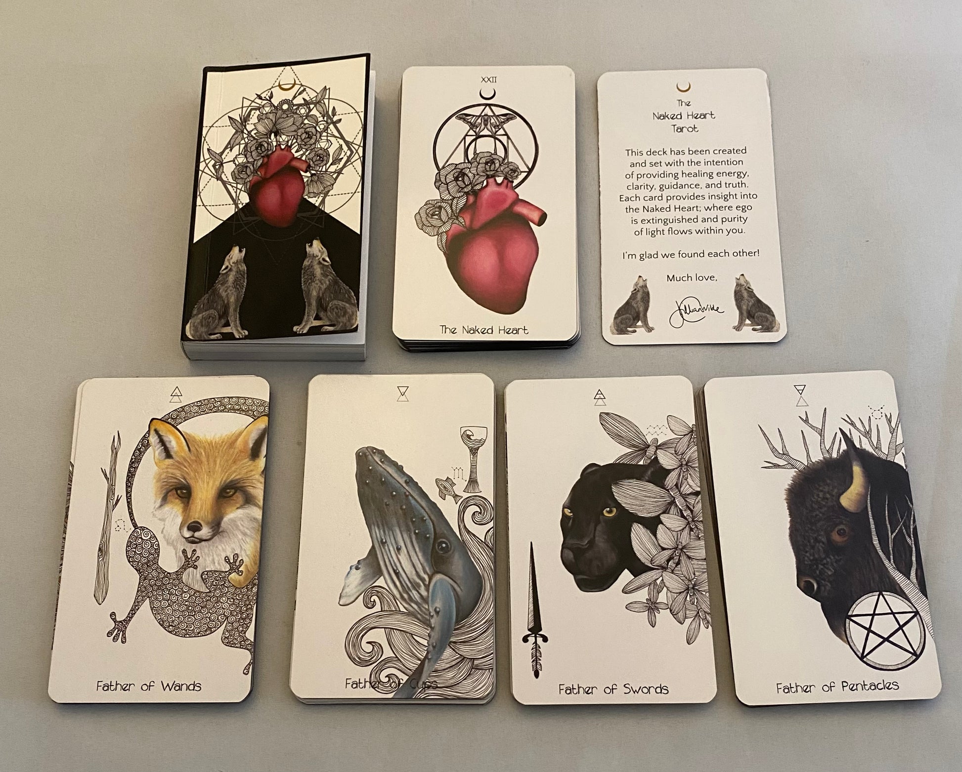Set of tarot cards with animal illustrations on a gray background