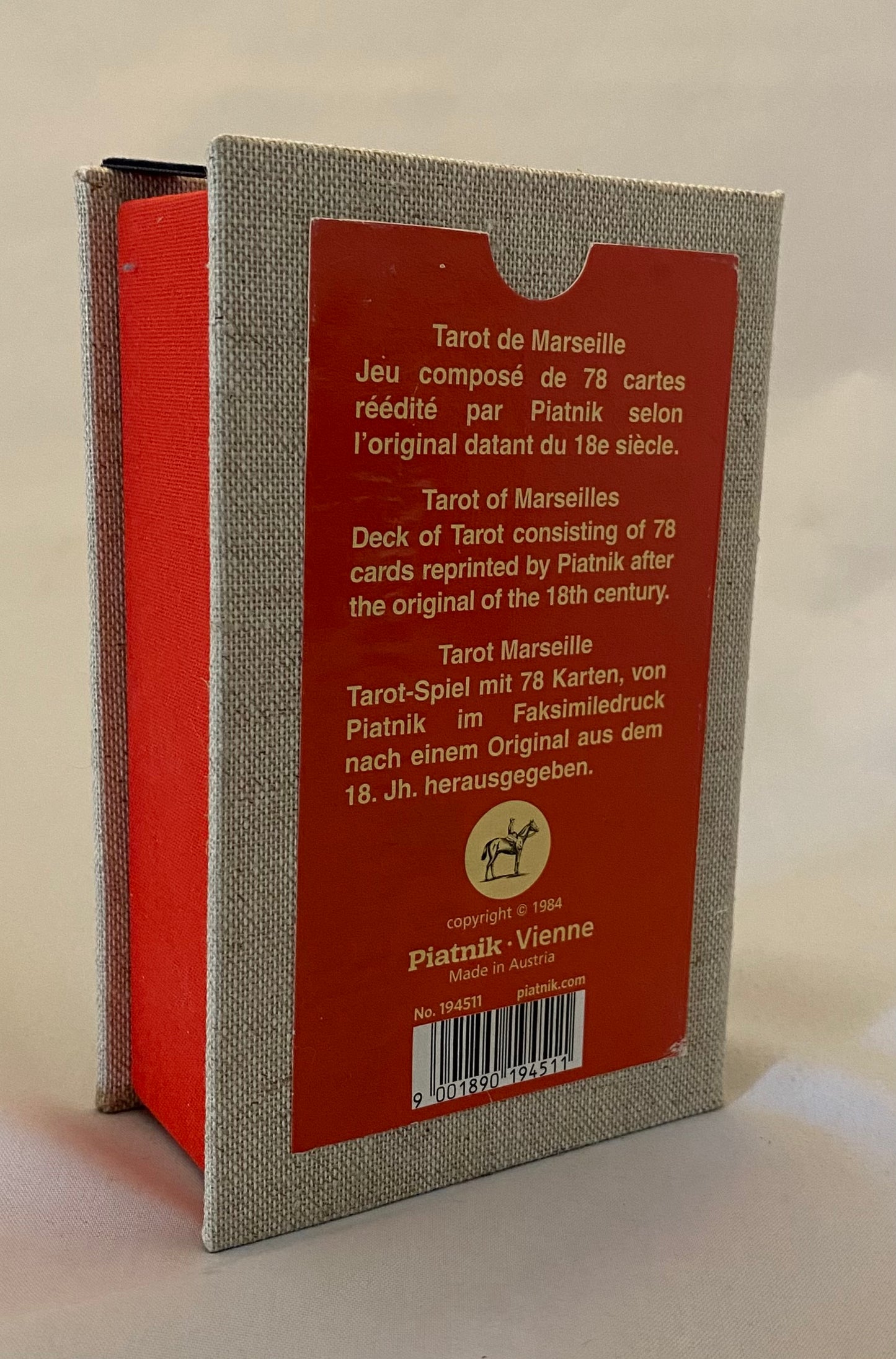 Back of a Tarot card box with text and a brand logo on a beige background