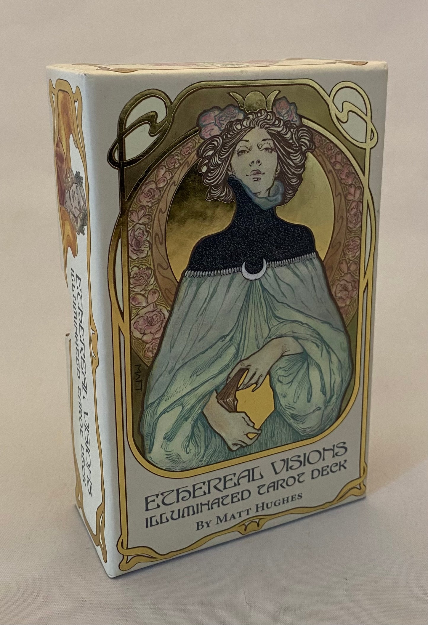Card deck packaging with artistic design of a woman and floral elements on a beige background