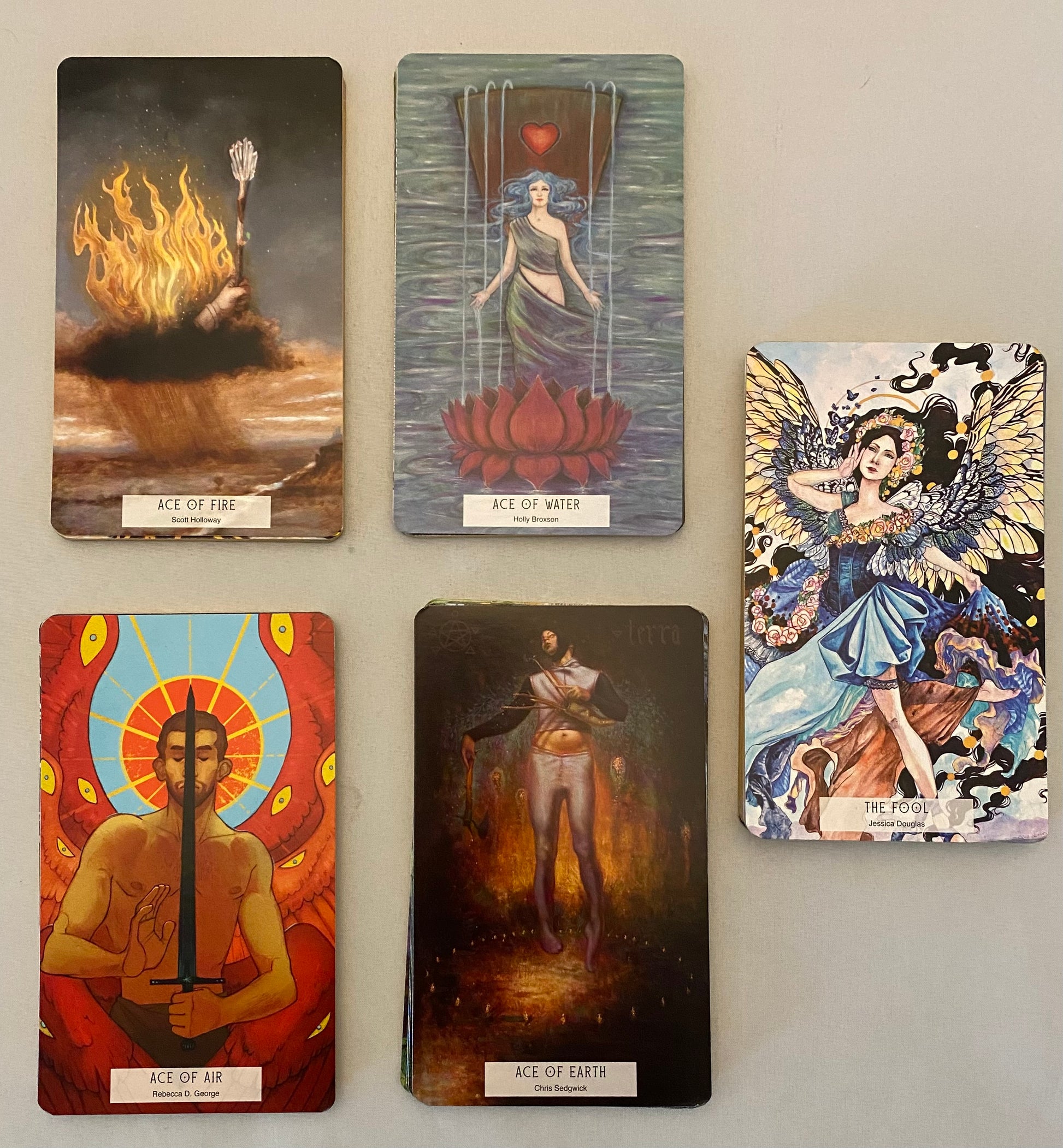 Collection of tarot cards displayed on a flat surface