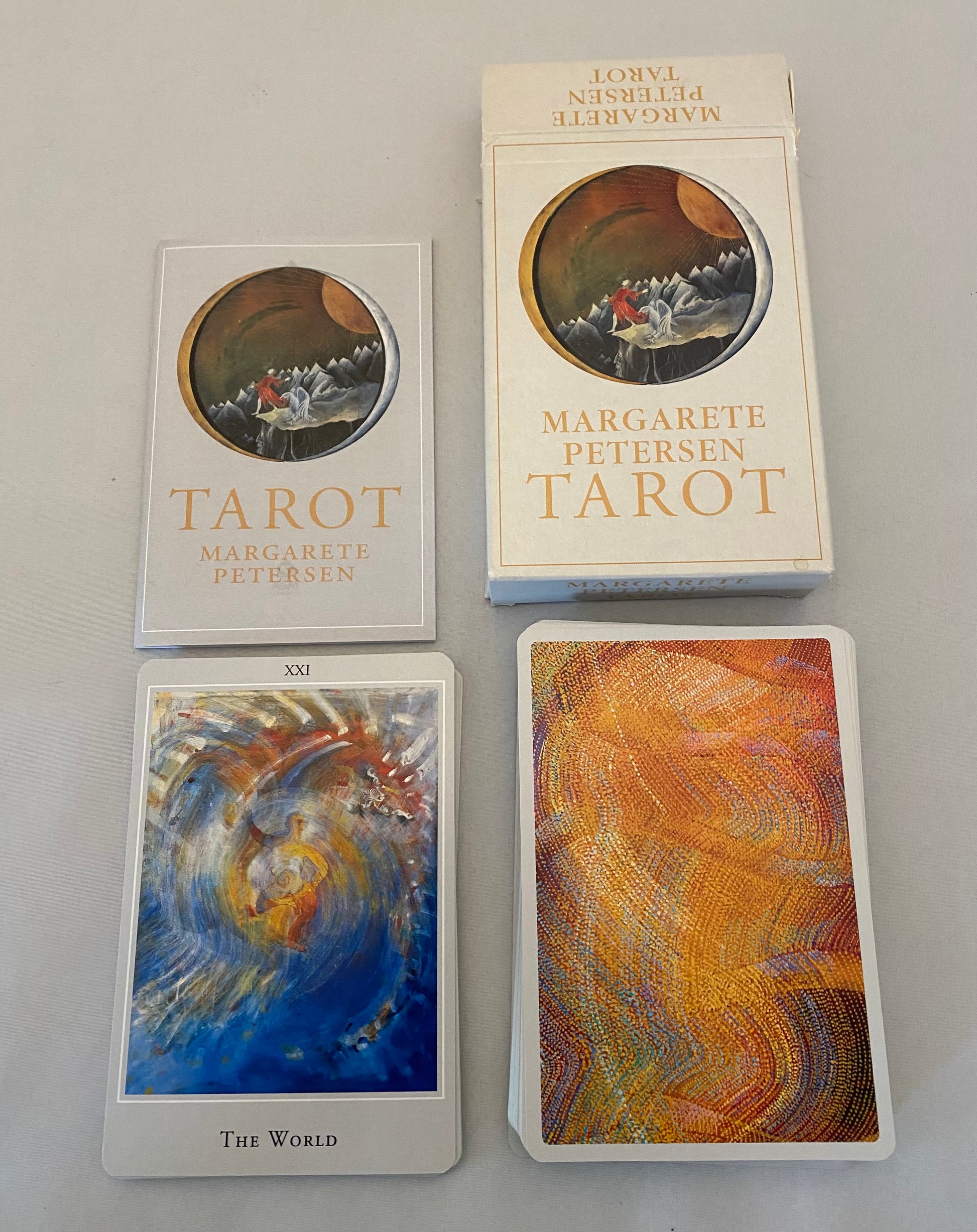 Tarot cards and packaging with 'Margarete Petersen Tarot' branding on a neutral background