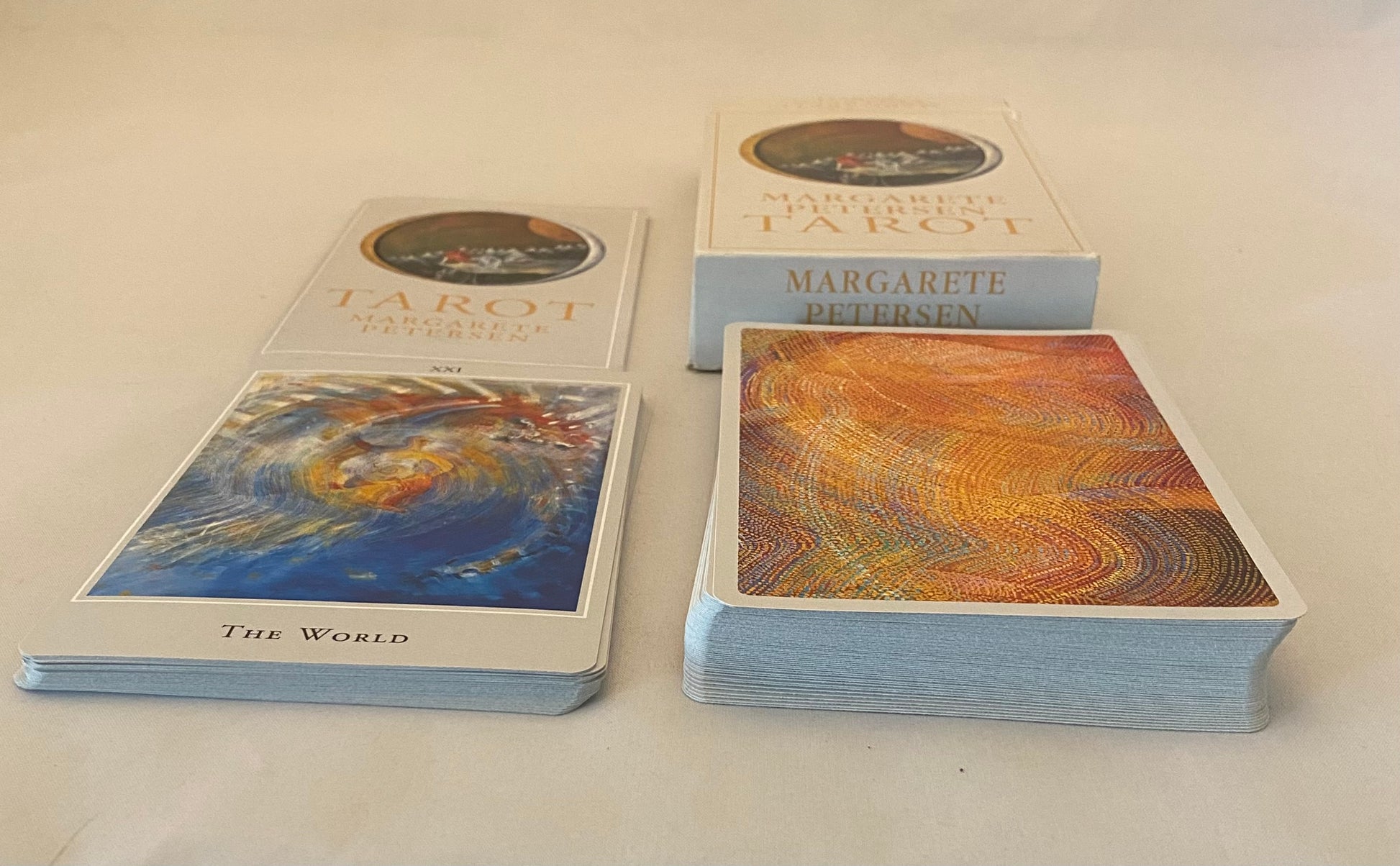 Collection of tarot cards and books on a light background