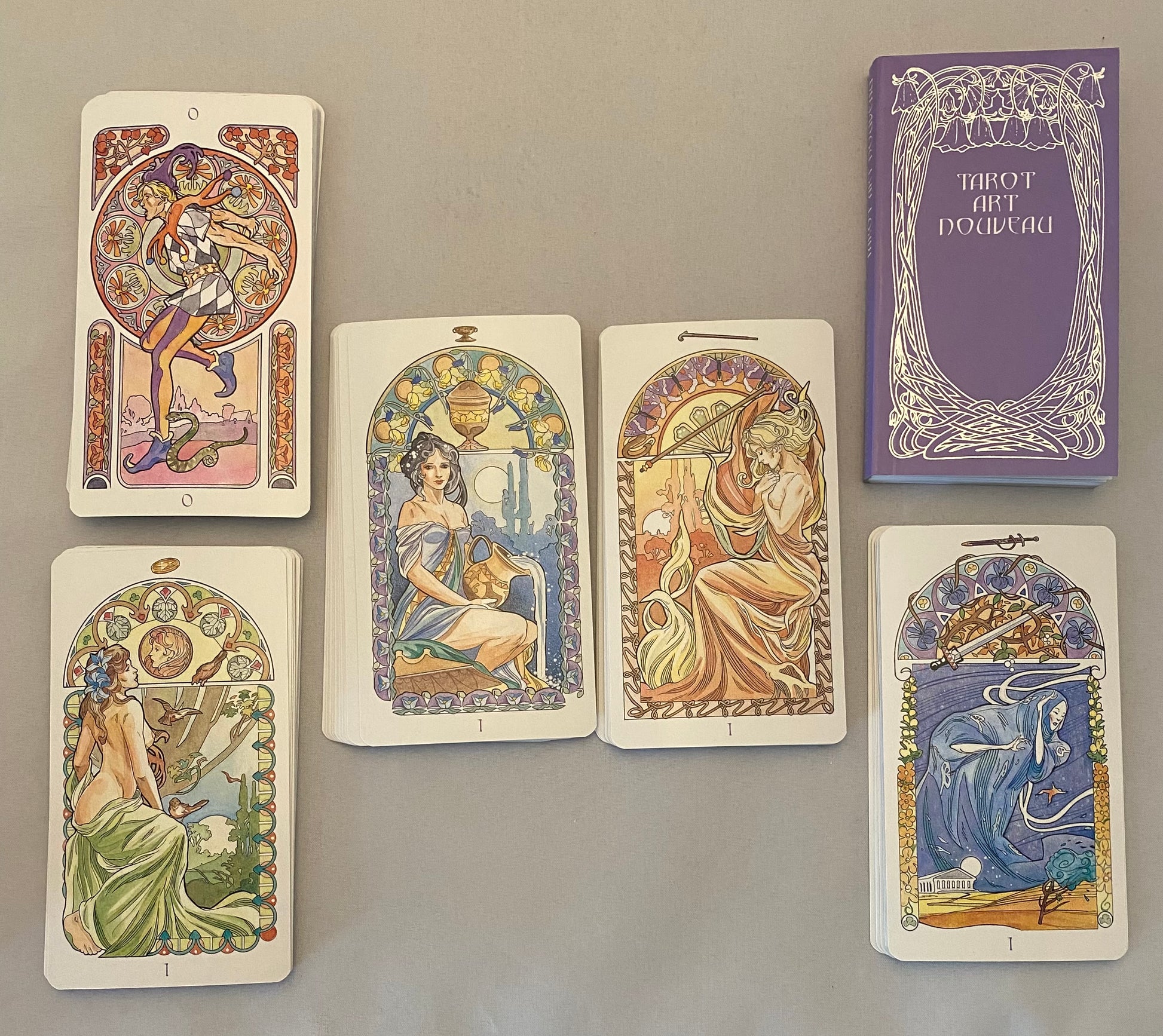 Set of tarot cards with decorative designs on a gray background
