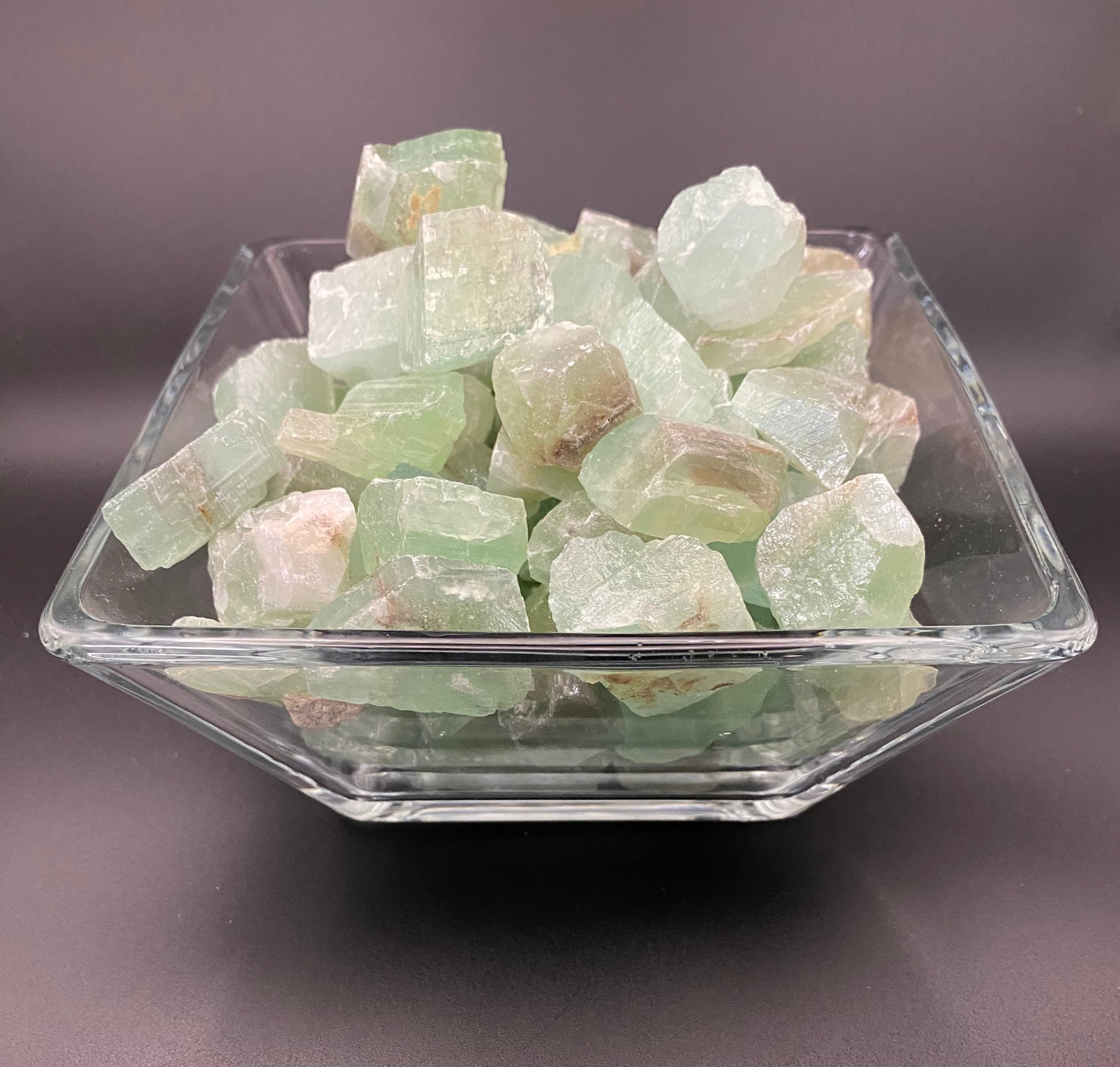 Green calcite chunks in glass bowl