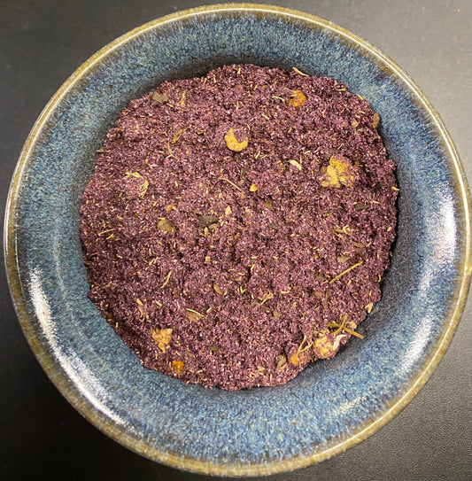 Healing Incense purple powder with herbal floral bits in