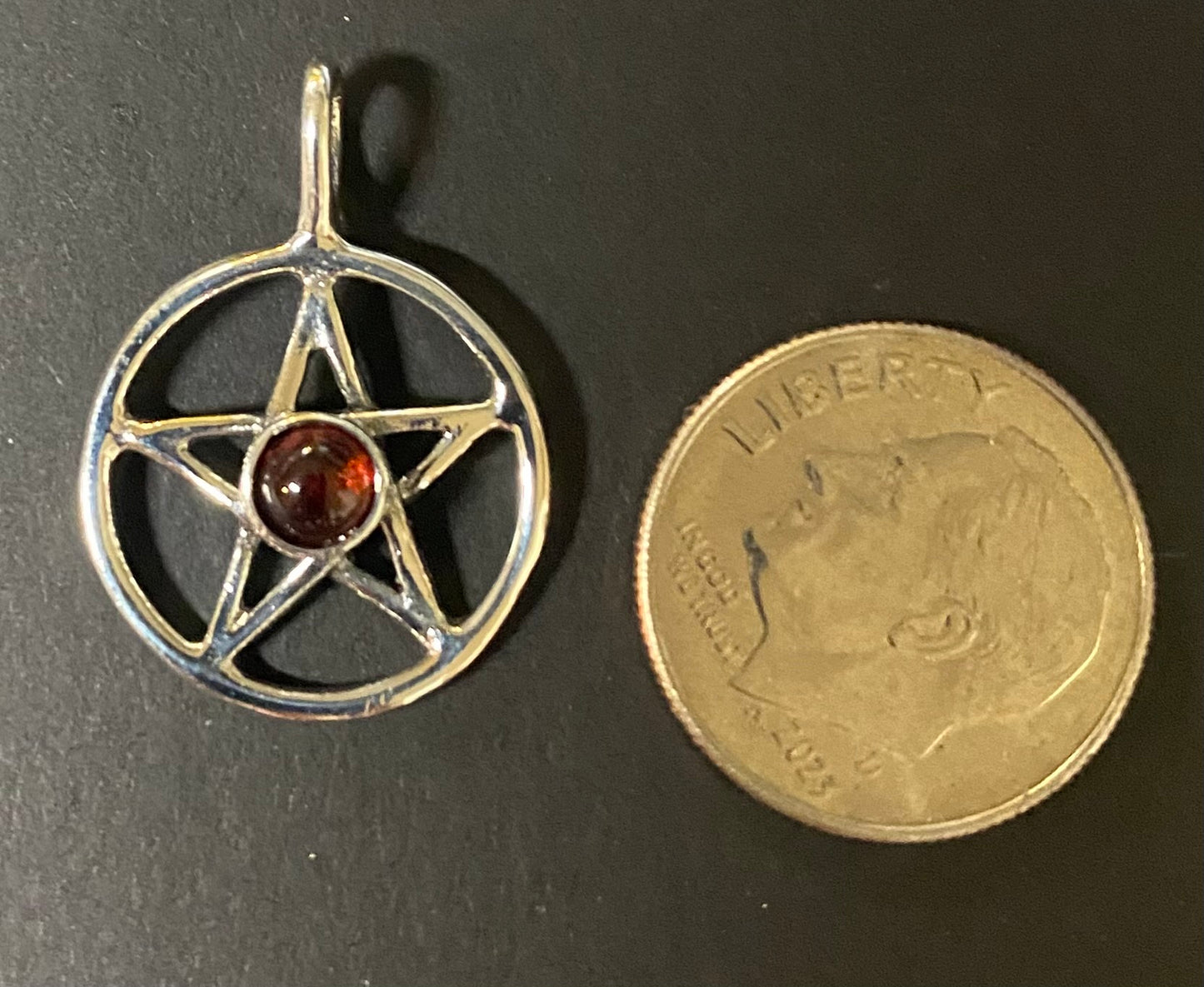 Pendant Pentacle with Garnet with a dime
