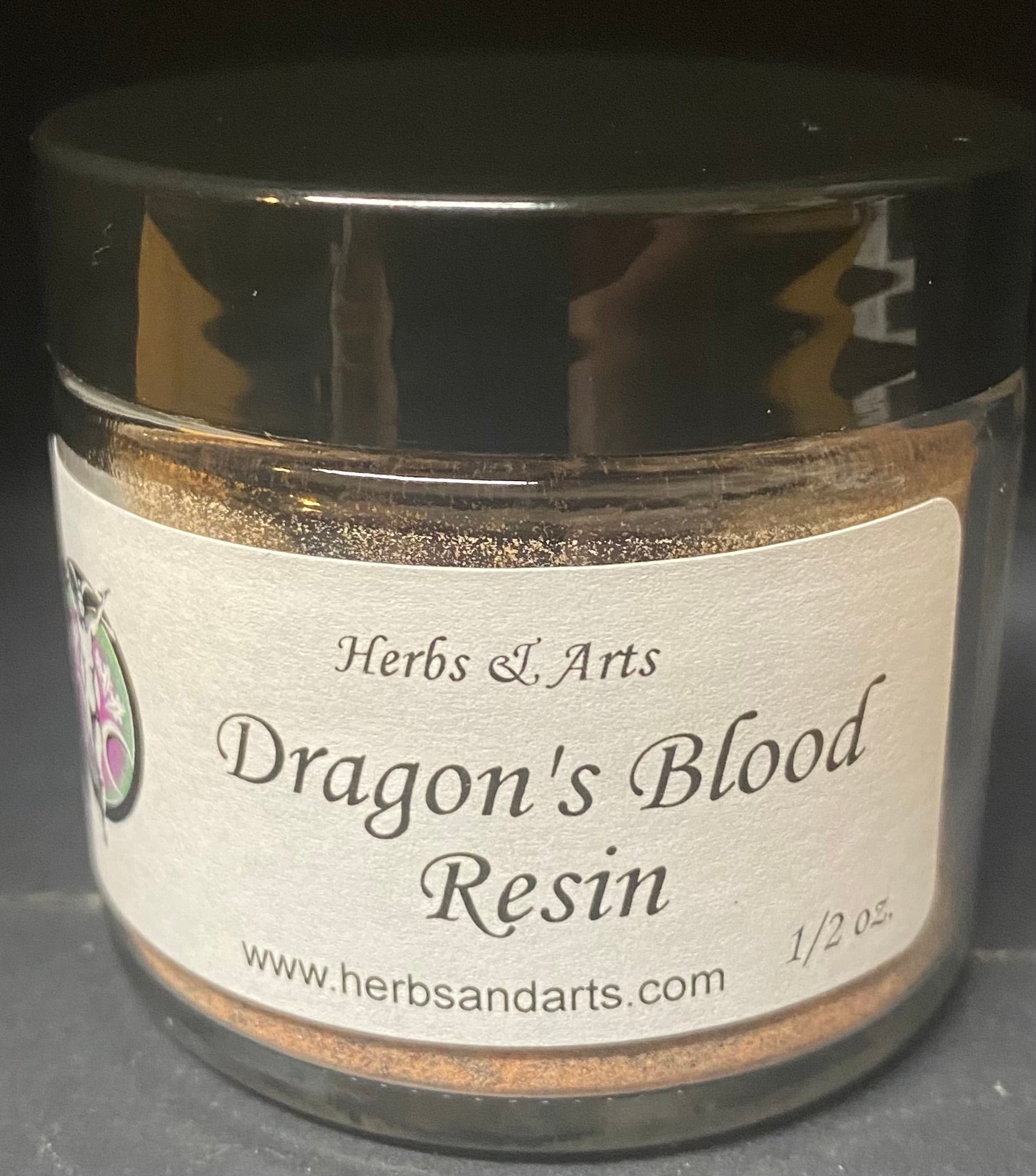 Jar of Dragon's Blood Resin with a label on a dark background