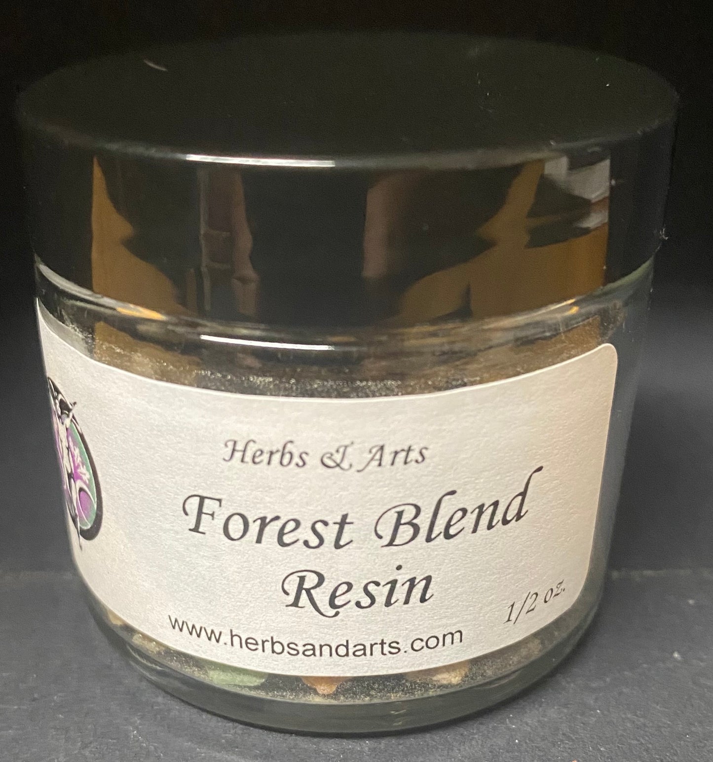 Jar of Forest Blend Resin with a label on a dark background