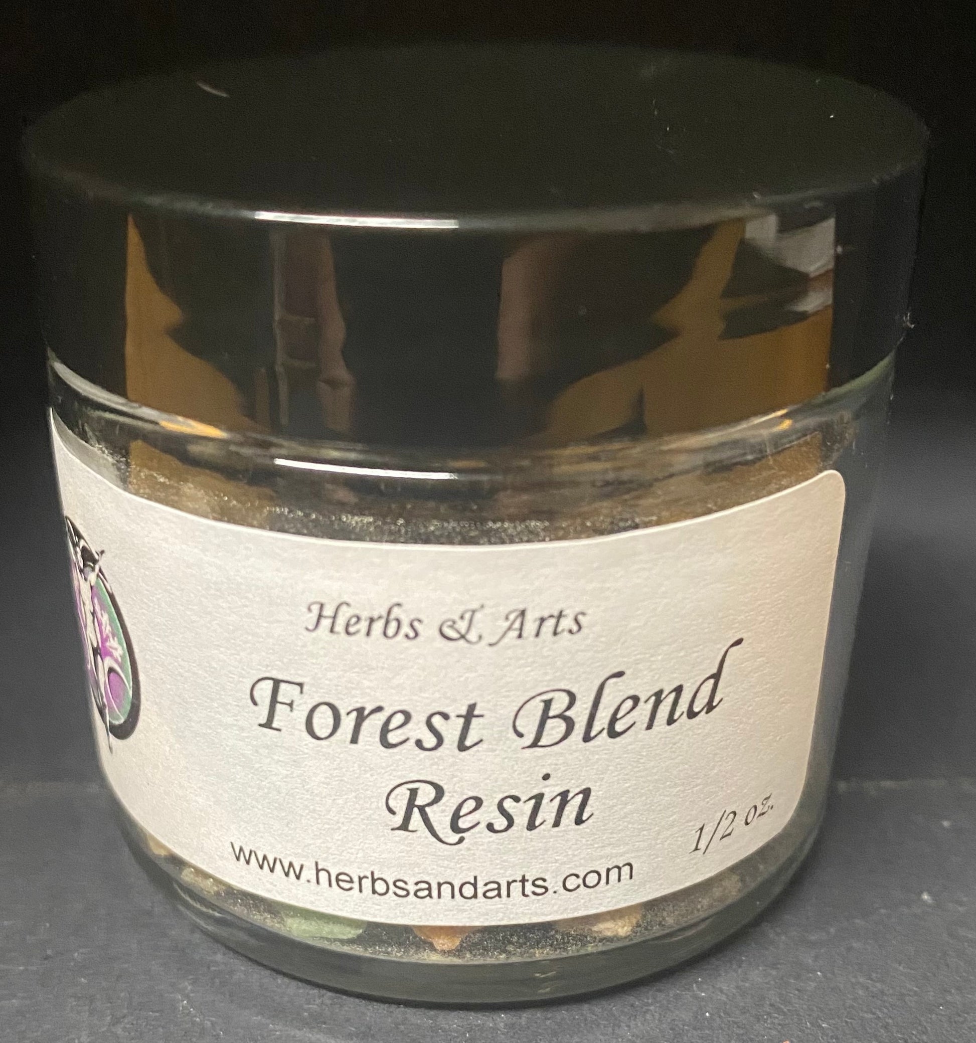 Jar of Forest Blend Resin with a label on a dark background