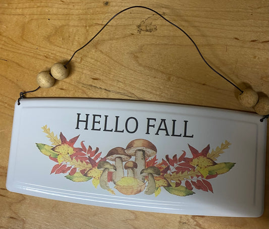 Decorative sign with 'HELLO FALL' text and autumn-themed graphics on a wooden surface.