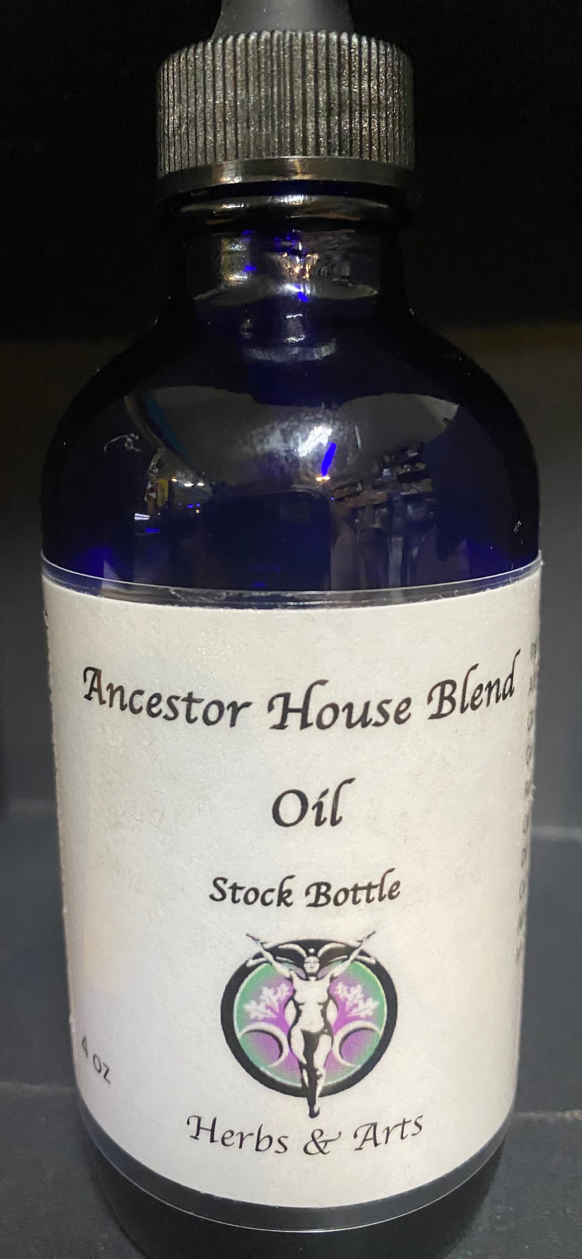 Bottle of Ancestor House Blend Oil with a label on a dark background