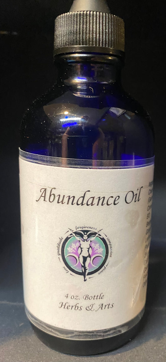 Bottle of Abundance Oil with a label on a dark background