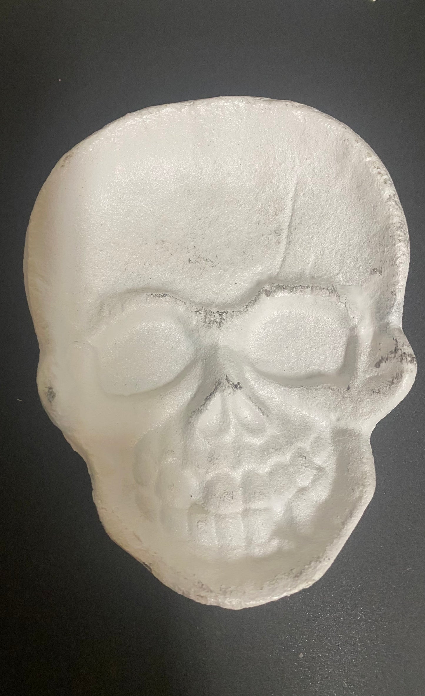 Skull-shaped object on a dark background