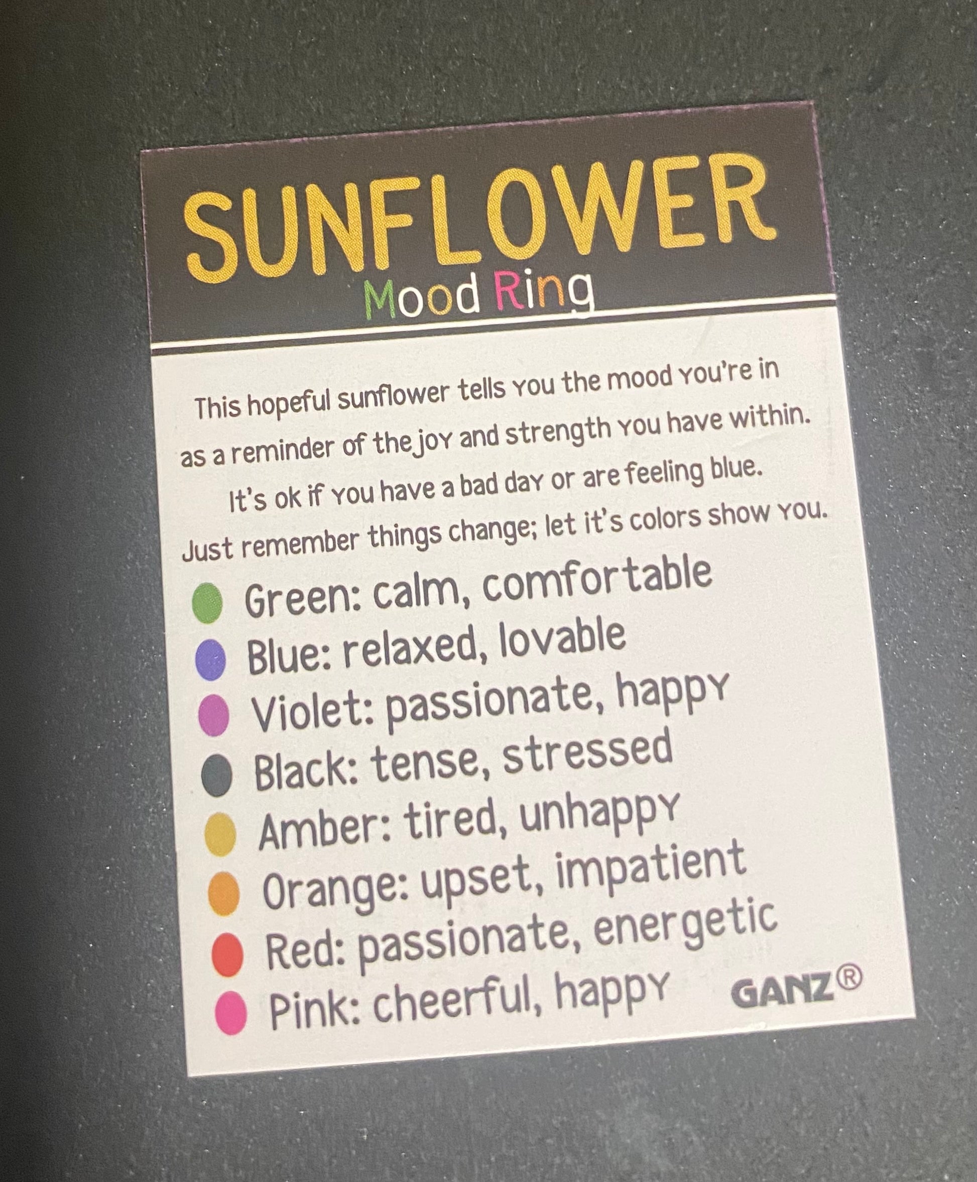 Mood ring label with color meanings on a dark background