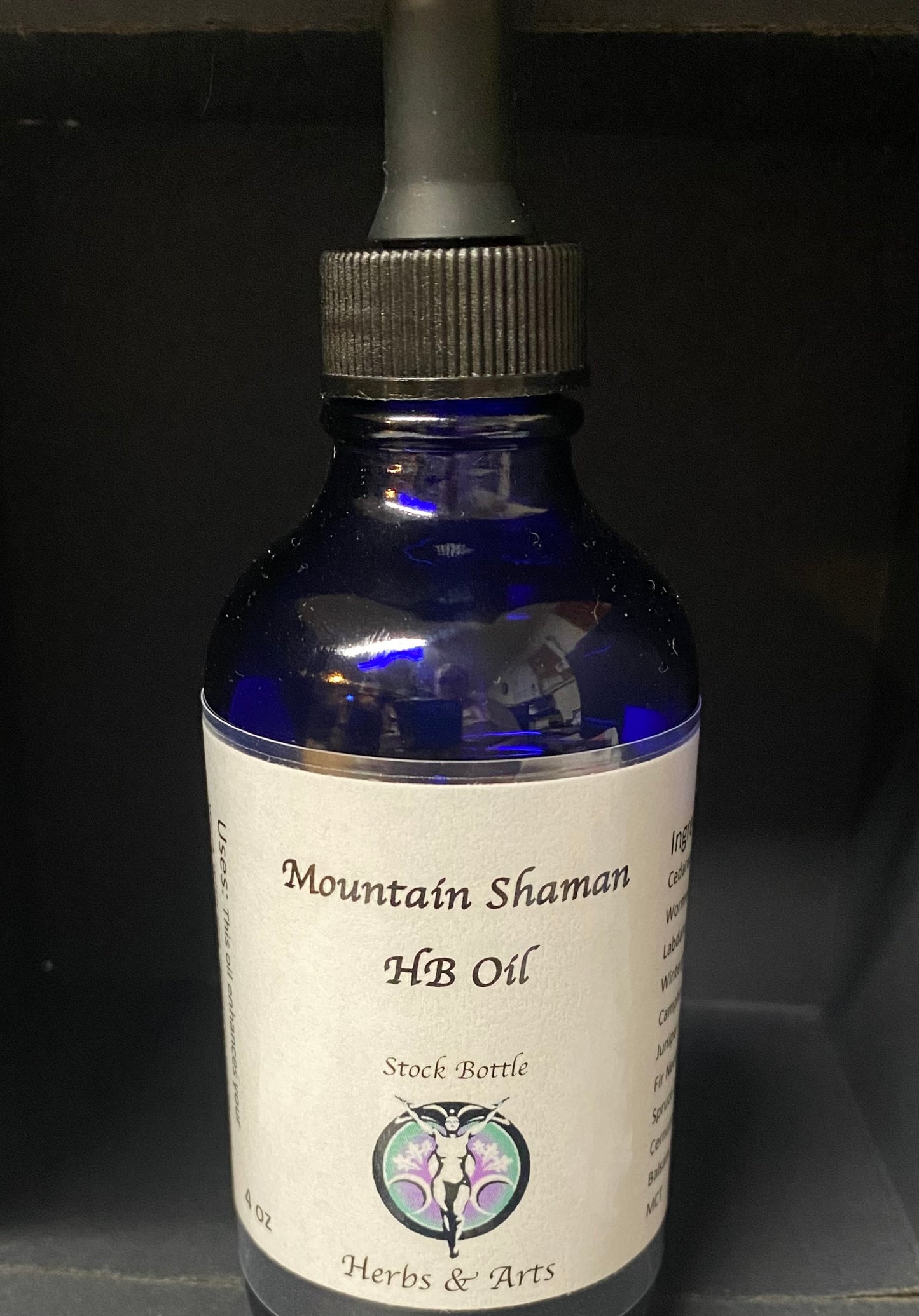 Bottle of Mountain Shaman HB Oil with dropper on a dark background