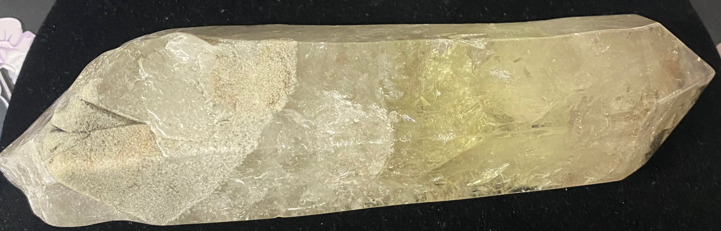 Crystal or stone with a natural, rough surface on a black background