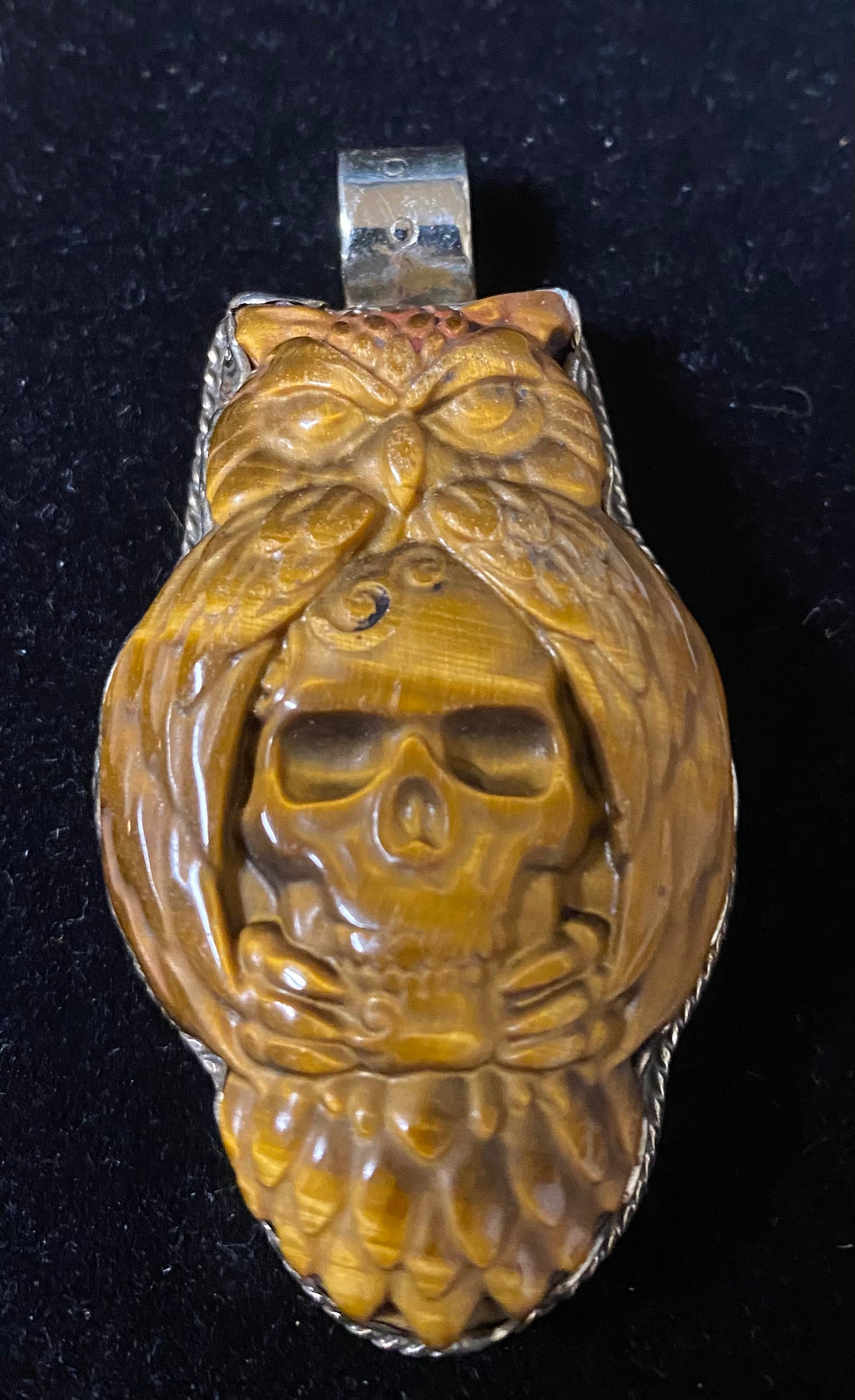 Pendant with a skull design on a black background