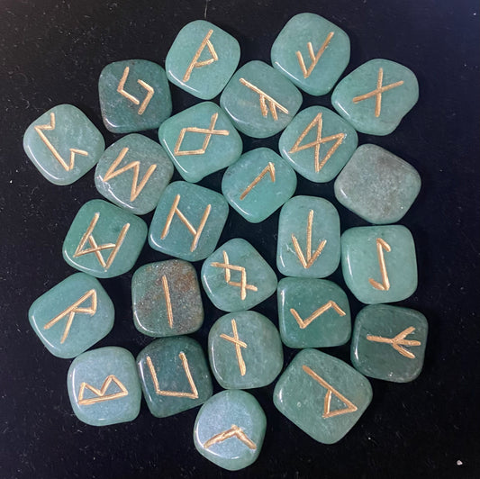 Rune Set Aventurine with gold runes on a black background