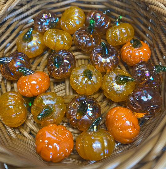 Pumpkin glass charms in a basket