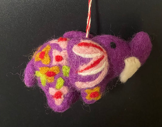 Decorative purple fish ornament with colorful patterns on a black background