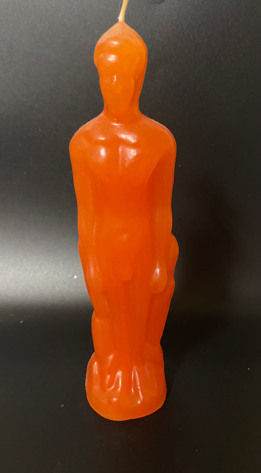Orange candle shaped like an Oscar statue on a black background