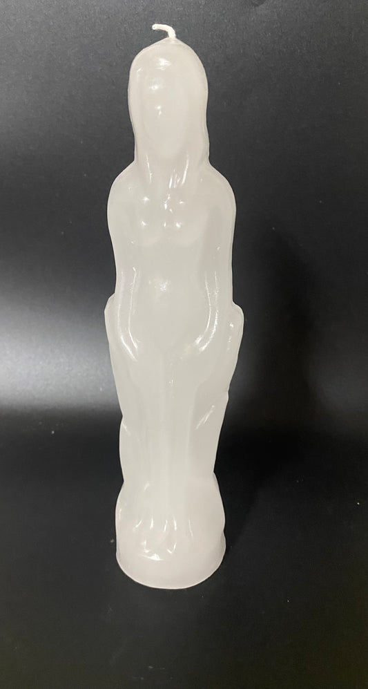 White candle shaped like a person on a black background