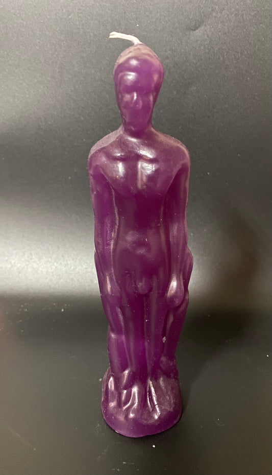 Purple candle shaped like a standing figure on a dark background