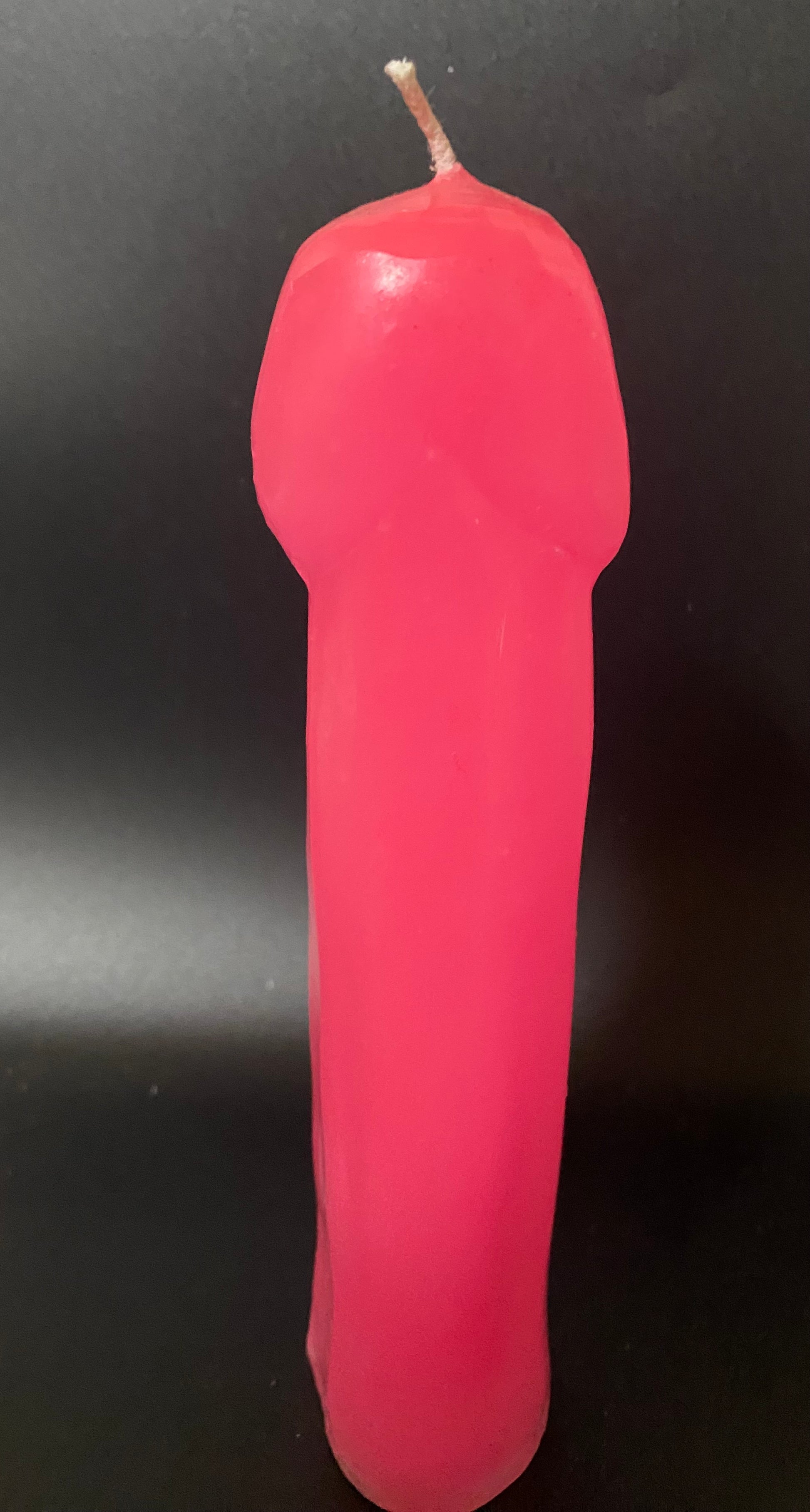 Pink candle on a black background