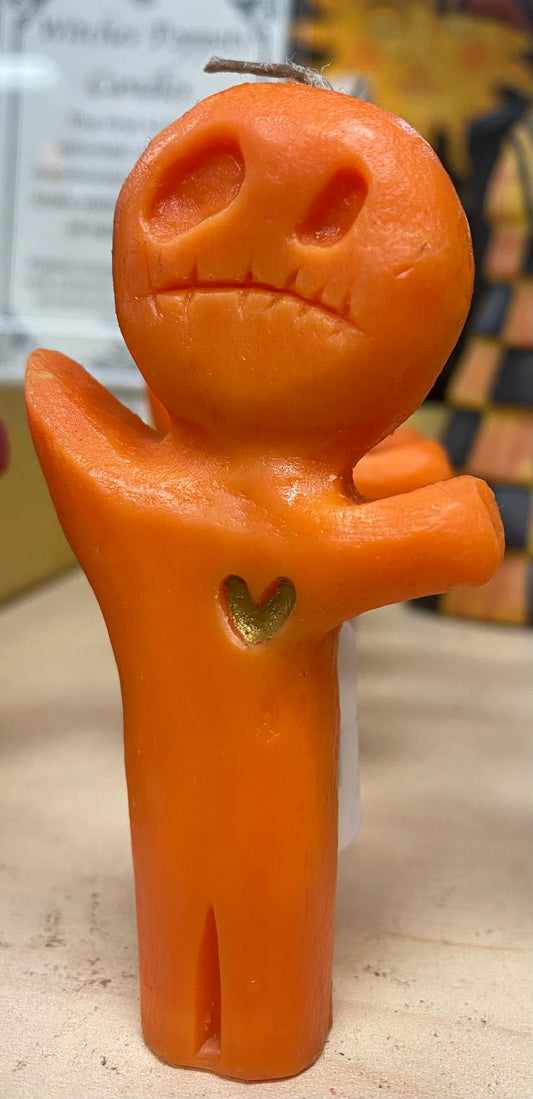 Candle with a face and heart-shaped detail on a neutral background