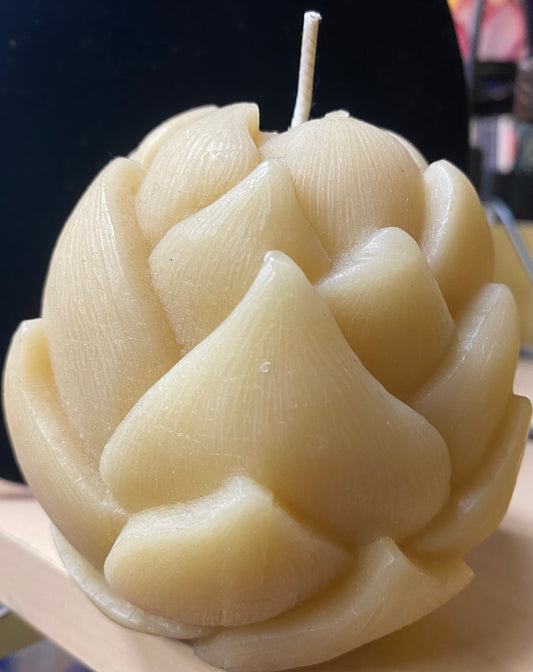 Decorative candle shaped like a flower on a black background