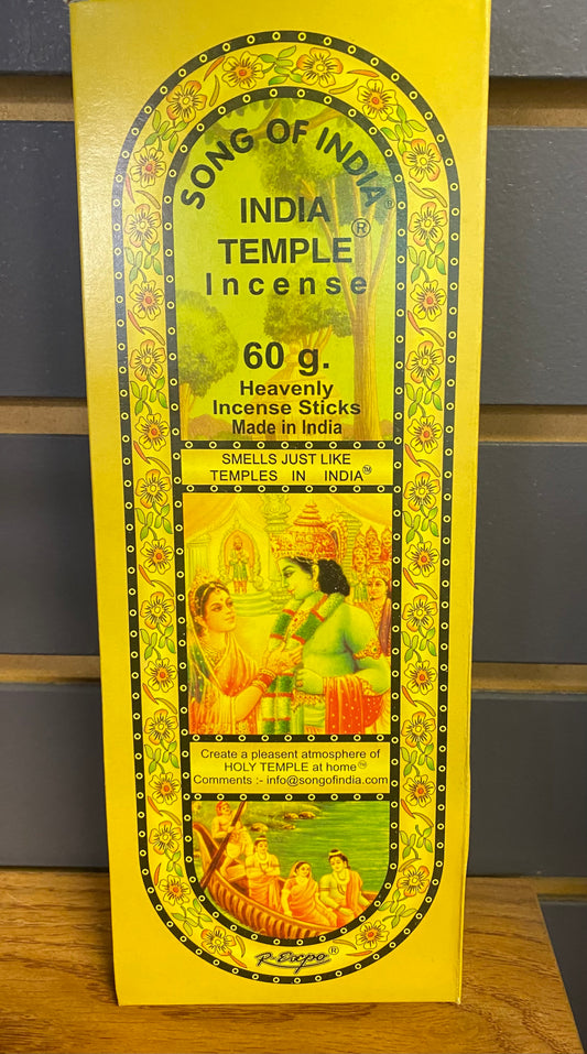 Box of India Temple Incense with yellow and green design on a wooden surface.