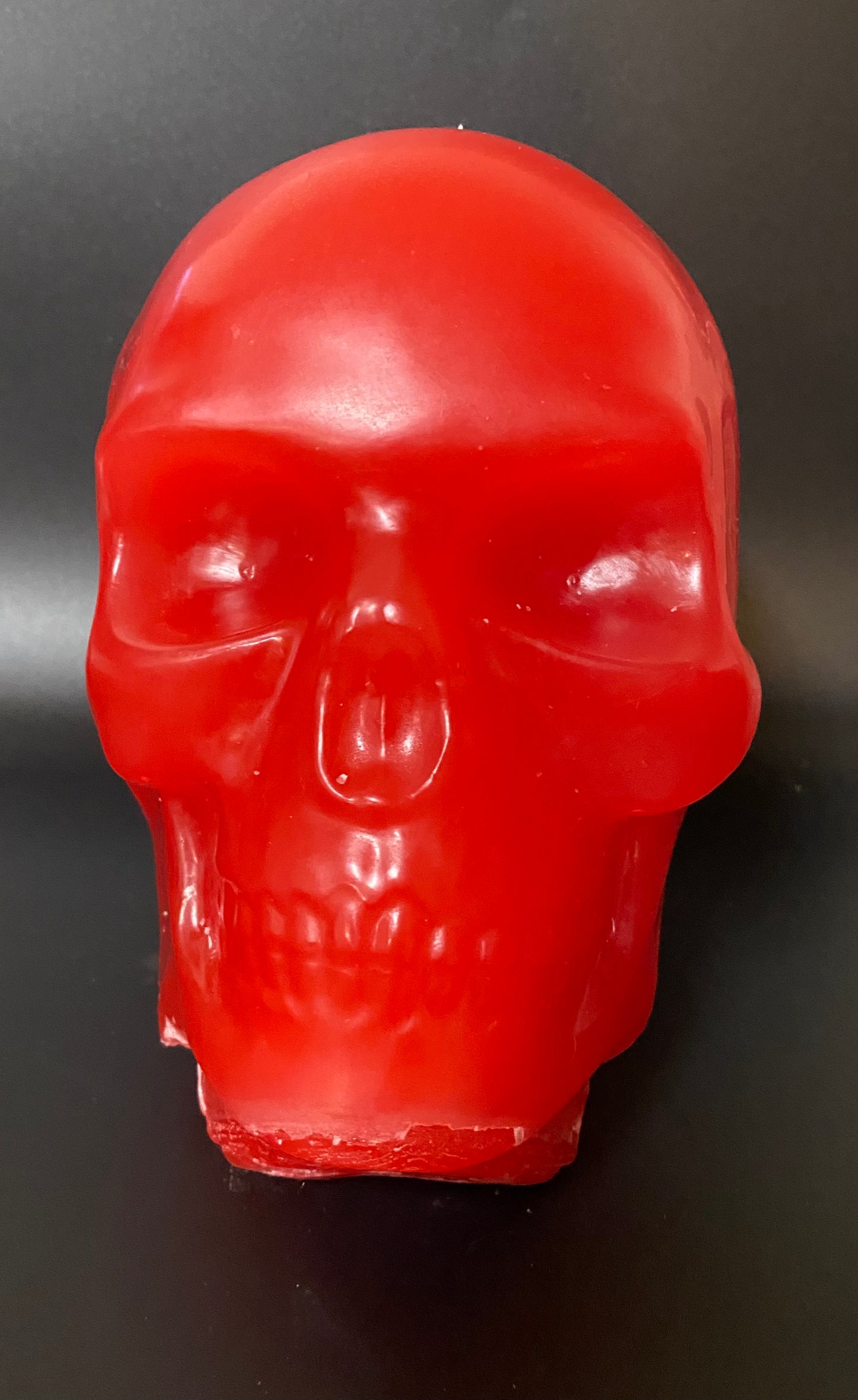 Red skull-shaped object on a dark background