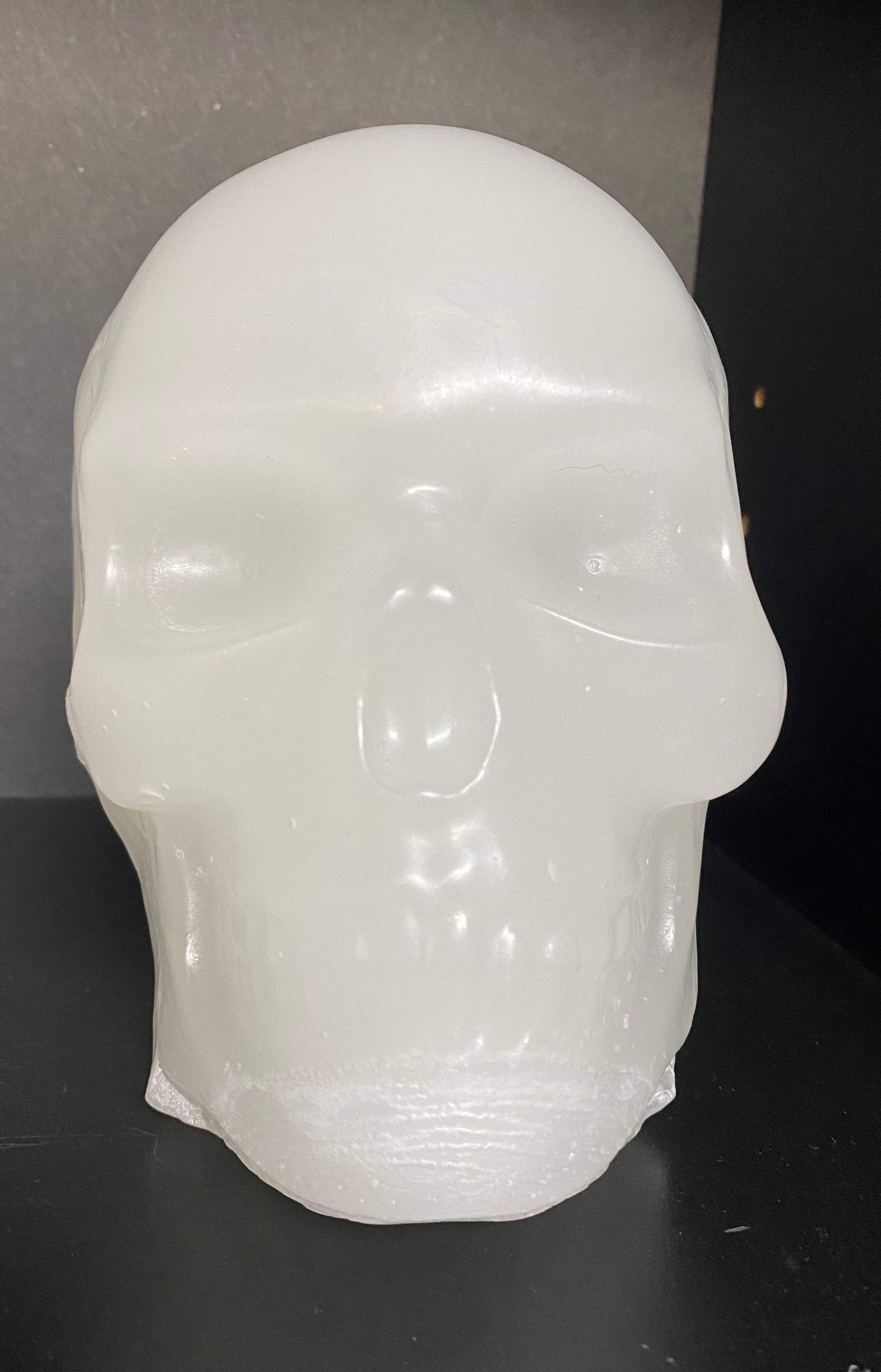 White skull-shaped object on a dark surface