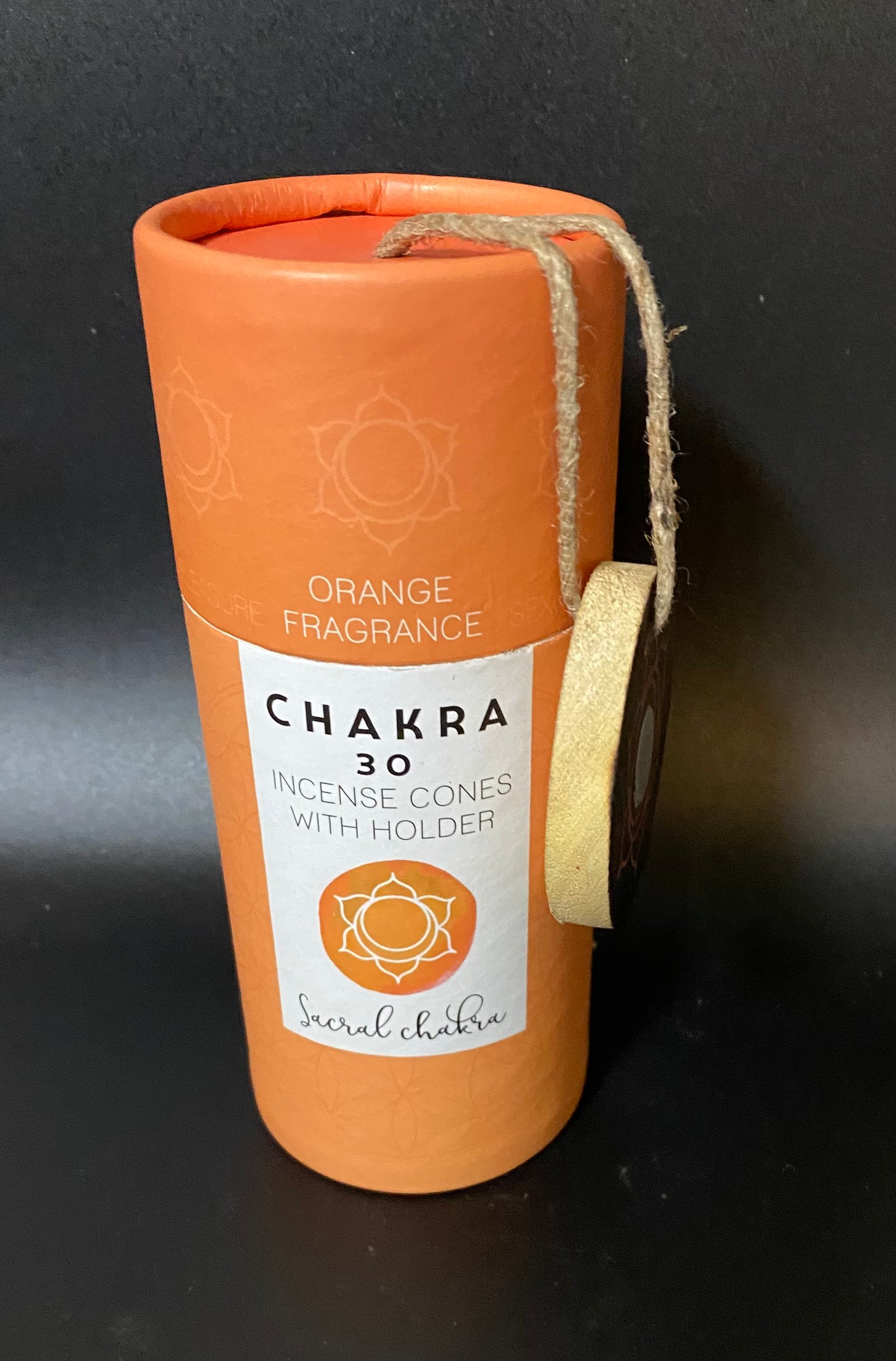 Chakra incense cones packaging with orange fragrance on a black background