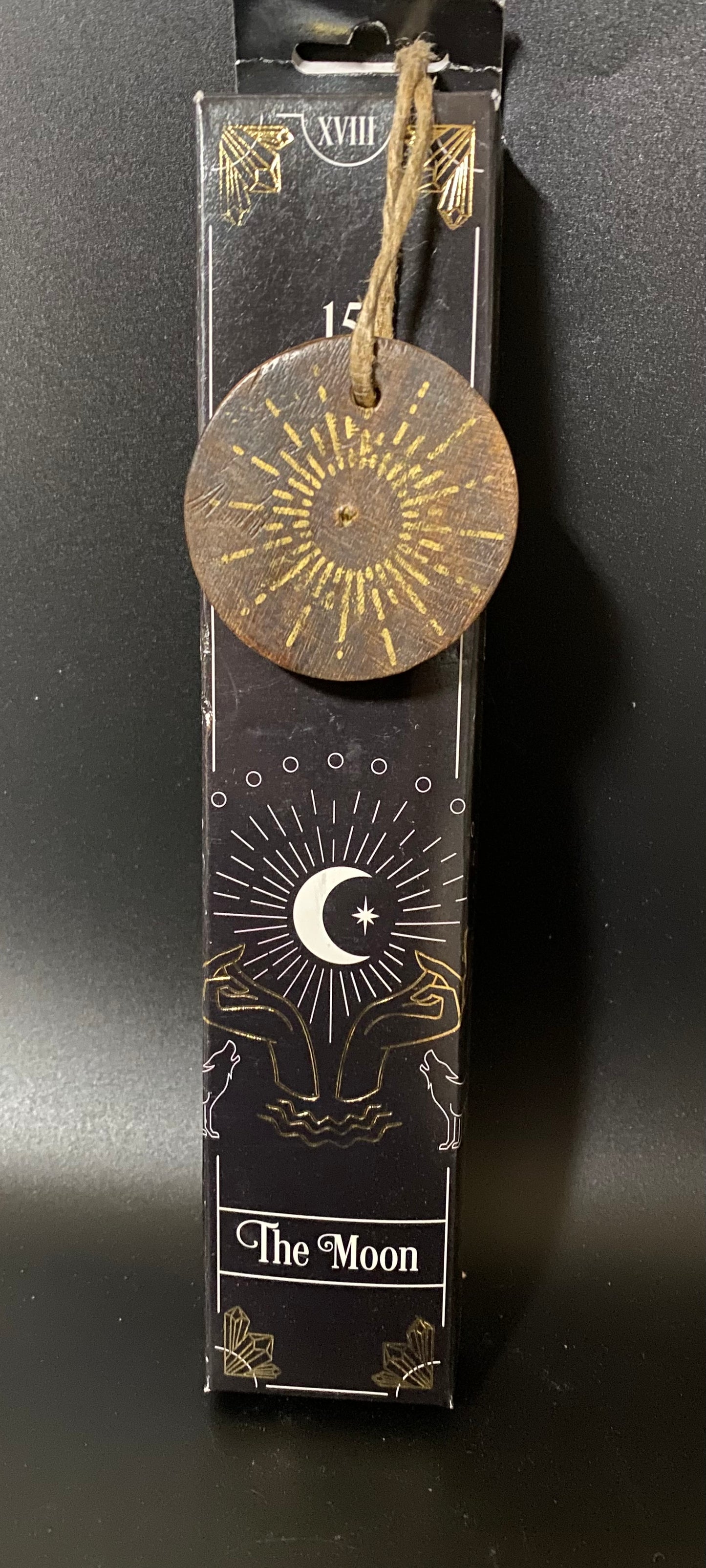 Decorative item with 'The Moon' design on a black background