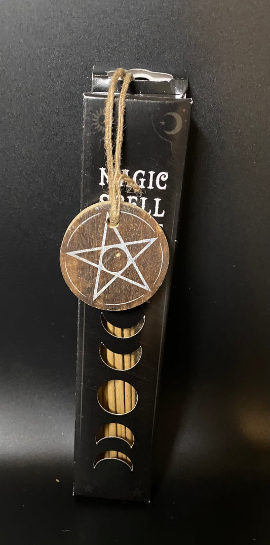 Decorative pentacle pendant on a string with a black background