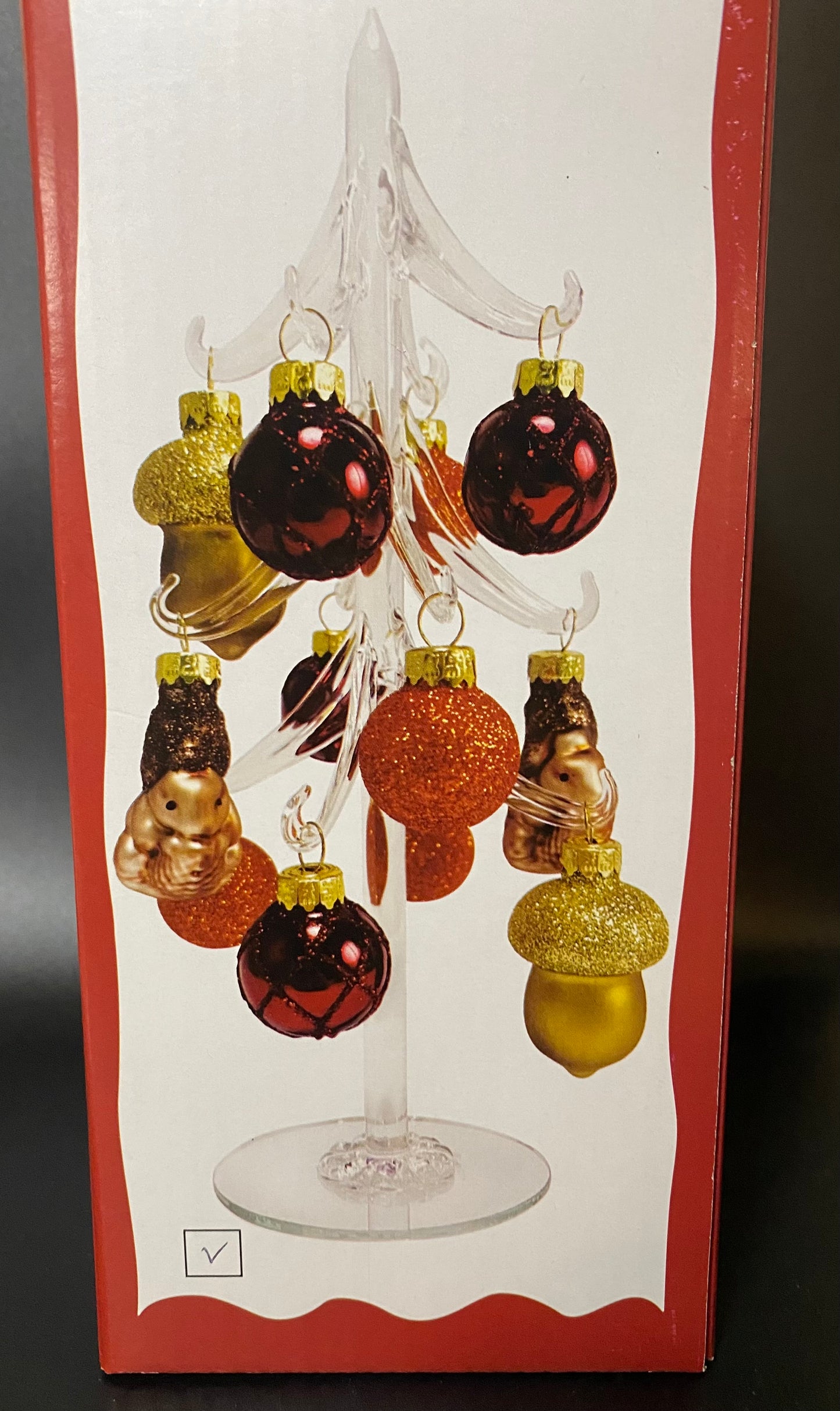 Decorative Christmas ornaments on a stand with a box background