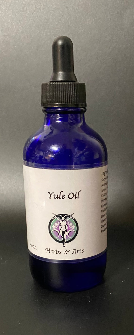 Blue bottle of Yule Oil with a dropper on a gray background