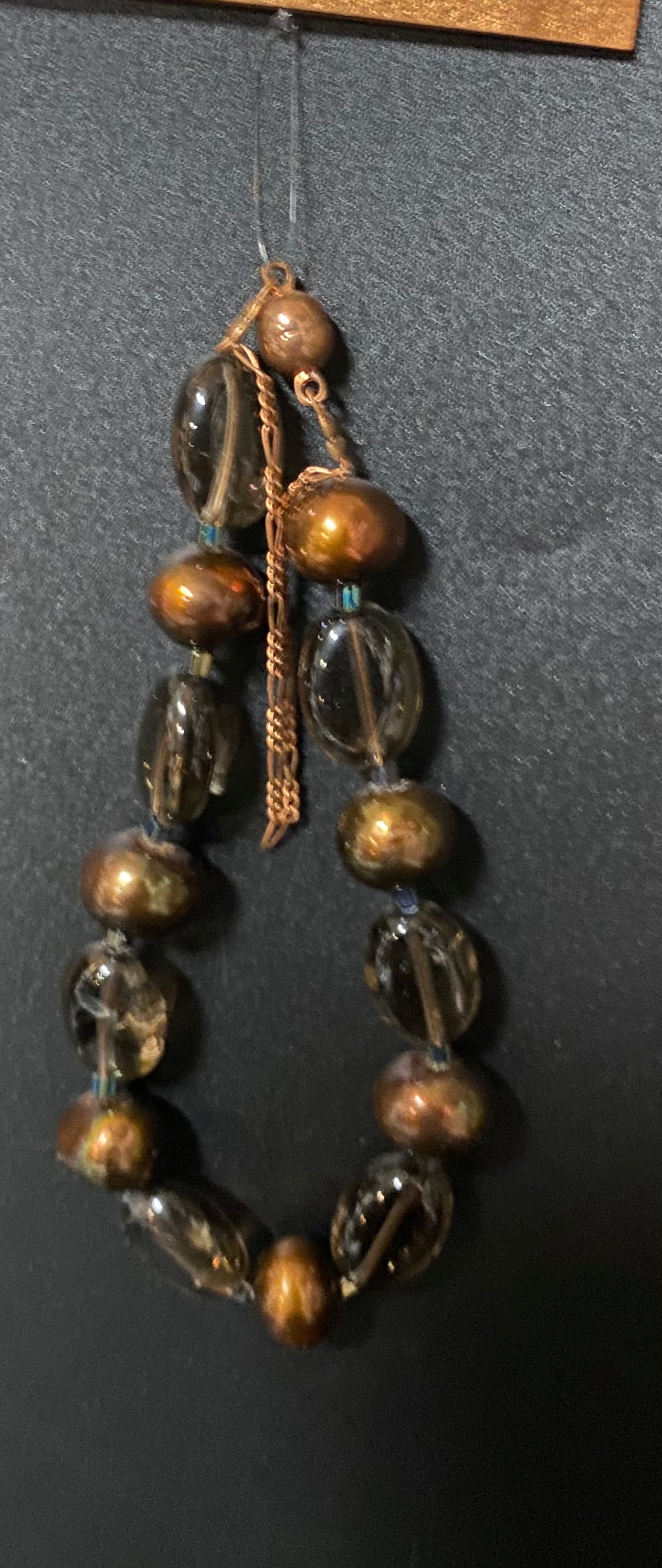 Decorative hanging with glass beads on a dark background