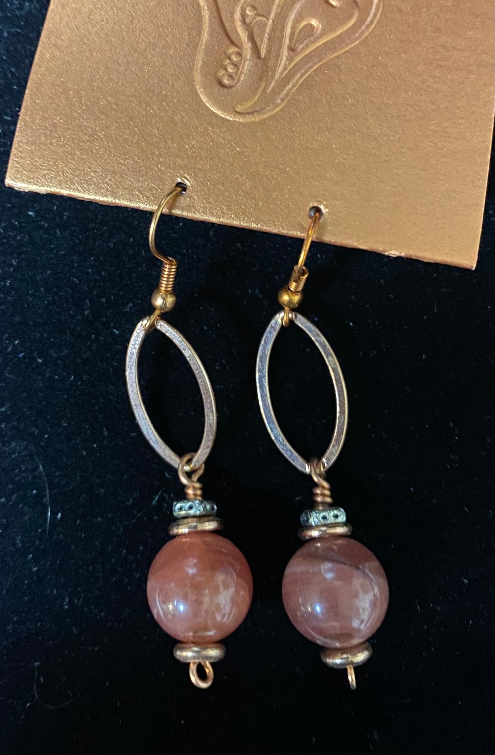 Pair of earrings with pink beads on a black background