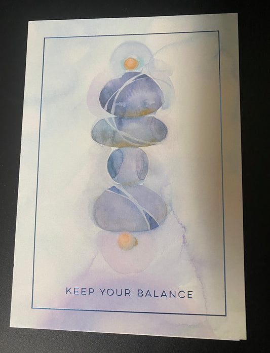 Stack of stones with 'Keep Your Balance' text on a watercolor background